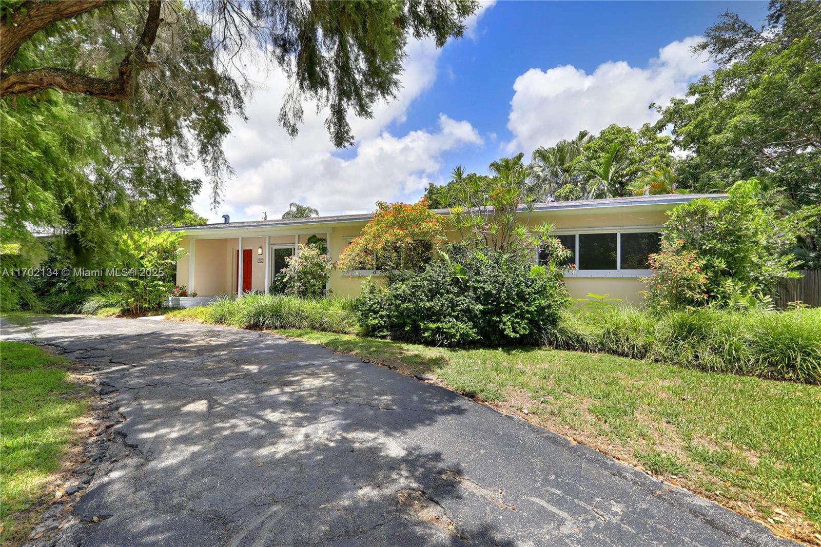 Spacious and airy, this 4 bedroom, 3 bathroom Pinecrest home features a new kitchen with quartz counters and stainless steel appliances, as well as all new impact glass windows and doors! The open living spaces feature terrazzo floors, and the living room has a beautiful pool view. Outside find a screened pool and extra-deep covered porch that is perfect for outdoor entertaining. The split floor plan includes the primary bedroom with a spacious walk-in closet and 2 additional bedrooms to one side, with a 4th bedroom with an en-suite bathroom to the other side. There is also an extra-large laundry/utility/storage room, plus a 2-car carport with additional storage. Located close to shopping, schools, and more, this is a fabulous opportunity!