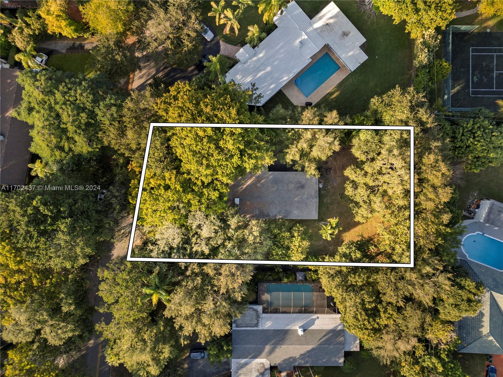 Welcome to this hidden gem in the heart of Pinecrest! Great location in a tree-lined and calm street next to $5M+ homes, ideal to remodel or build your dream home. 4 bedrooms, 2 bathrooms home with 18,500 SF lot perfect for investment! Wood beam ceilings in living areas, family room, gas fireplace, 1 car carport, impact windows and doors throughout With ample space and a solid structure, it can be transformed into a magnificent residence or bring your architect and builder to bring your vision and creativity to transform this property into your luxury dream home.
