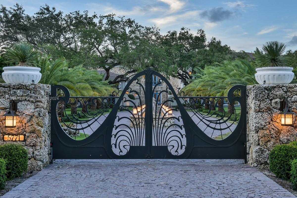 Generational one-of-a-kind estate on almost two acres in North Pinecrest, featuring luxury from both the “old world” and the new, with 8 bedrooms, 7 bathrooms, 2 half-bathrooms and incredible formal spaces for all. Designed by Portuondo Perotti Architects, the interior reflects a classic design with Art Nouveau inspiration, soaring ceilings, custom details, and unique features throughout. The grand entrance is surrounded by a 7-ft high coral stone wall, leading to a 200-ft long driveway and a centerpiece with a 107-ft water feature and Triton sculptures. Outside features include elegant exterior lighting, beautiful landscaping, French garden with English hedges, tennis court, 60-ft long pool, spa, and a variety of outdoor living spaces.