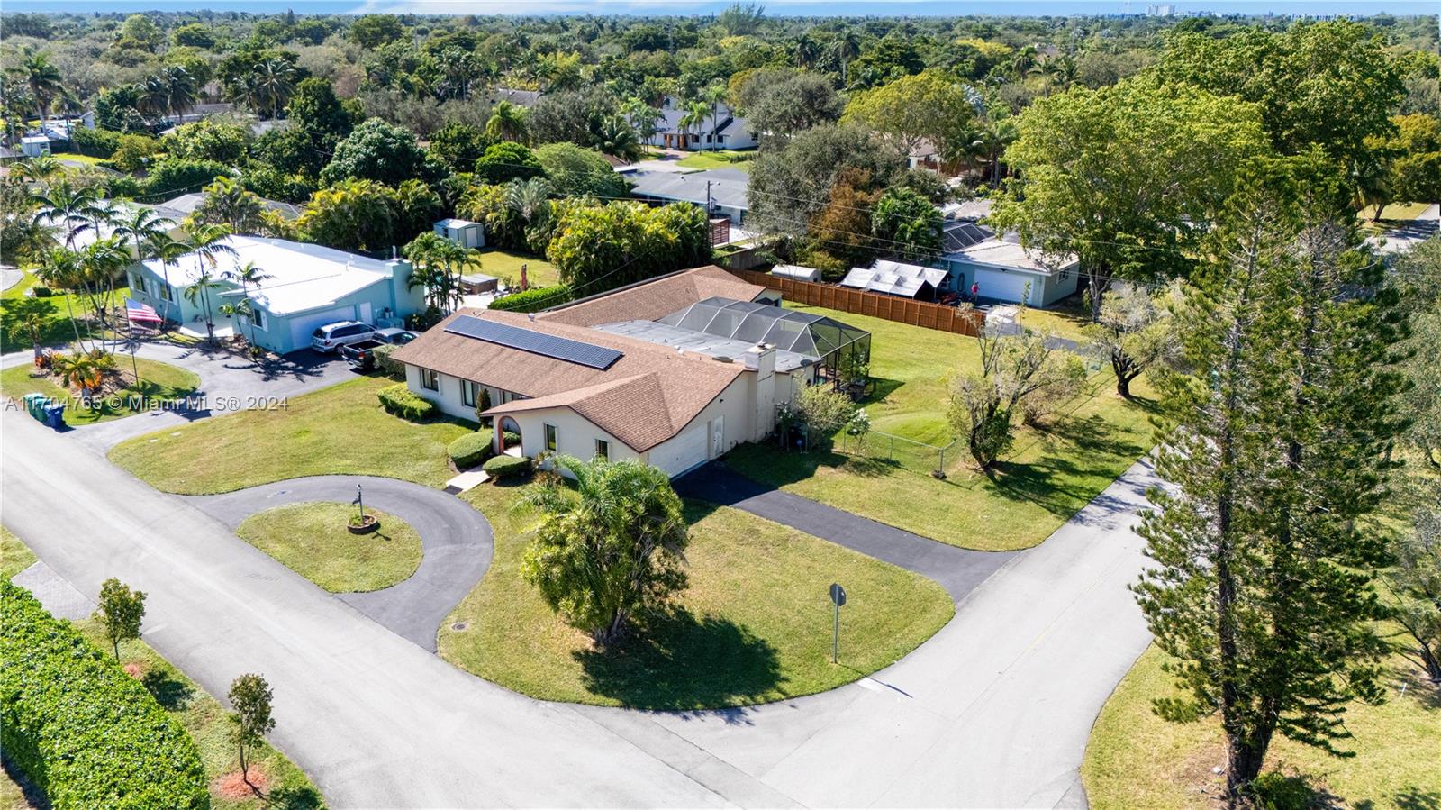 This well-located Palmetto Bay Corner Lot home features a versatile layout and plenty of natural light, awaiting your personal touch. This 4-bedroom, 4-bathroom residence includes two spacious master suites with direct access to a serene screened pool area, perfect for relaxing or entertaining. The home features elegant wood and porcelain floors, a den/office, a fenced-in yard, 2021 solar panels for energy efficiency, a water softener, accordion shutters throughout, and a double-car garage. Situated on a large lot, this property combines comfort, style, and convenience in a sought-after location.