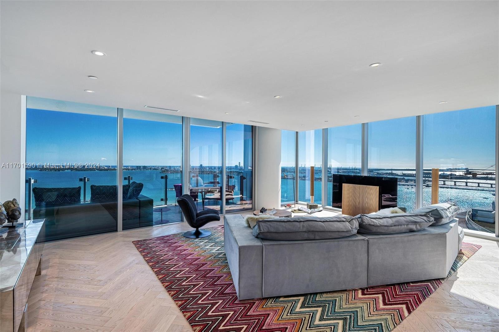 Experience the epitome of luxury living in one of Miami's most coveted waterfront addresses. This custom-designed combo corner residence offers 2 bedrooms, 2.5 baths + den, with a private foyer. Residence features panoramic views of the serene bay, ocean & vibrant city skyline, from sunrise to sunset. Every detail has been thoughtfully curated, from the imported herringbone parquet floors & bespoke custom closets to the refined Henge light fixtures. The residence is adorned with iconic design houses such as Henge, Baxter & Missoni Home (furniture to be negotiated in addition to). Ideally situated with a perfect walkability score, mins from Miami's best dining and shopping. Residents enjoy access to five-star amenities, including three pools, a luxurious spa and sauna, a tennis court & more