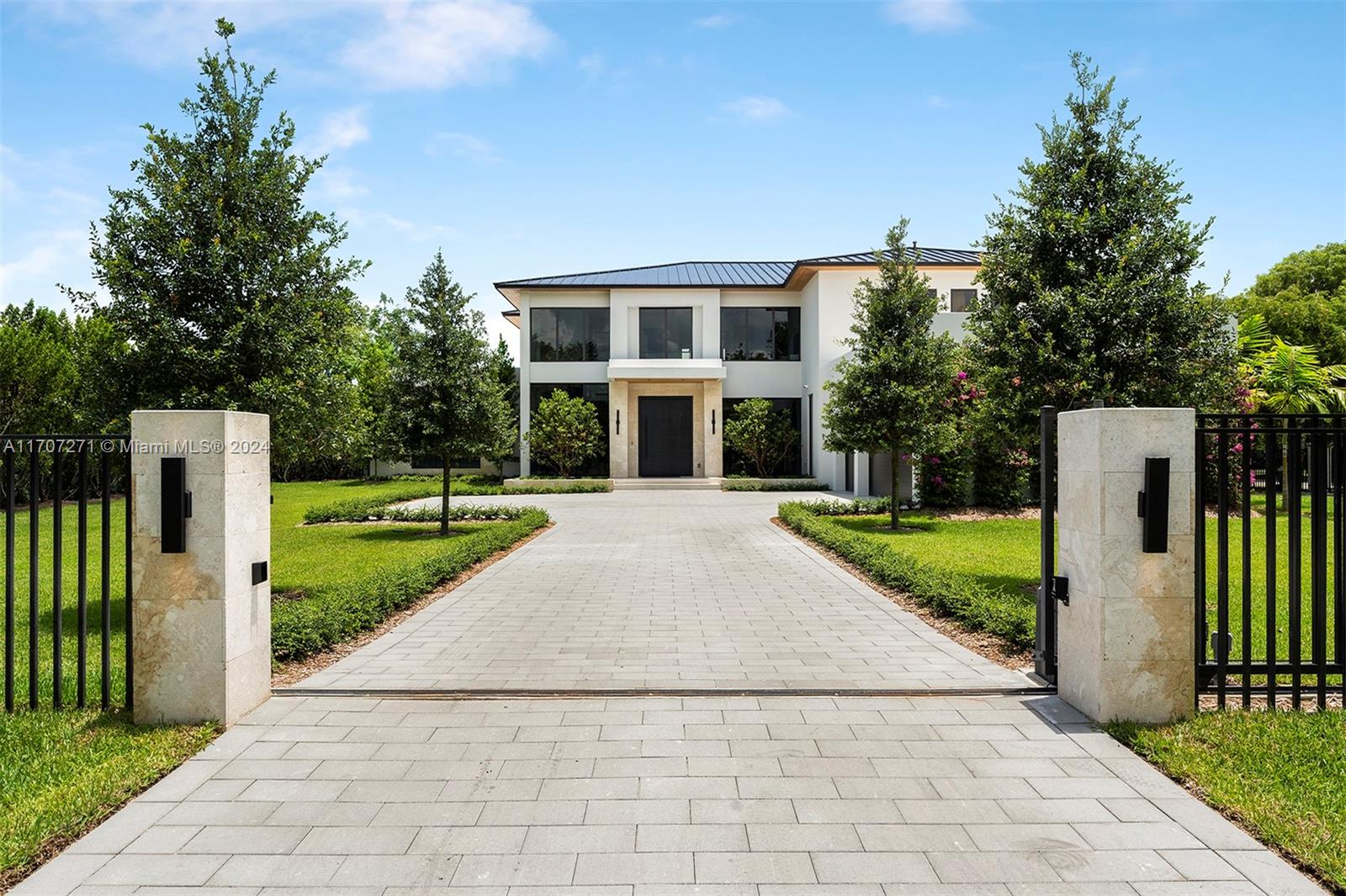 Step into this transitional contemporary masterpiece located in Pinecrest. This home features 7 BD, 8.5 BA, & impressive double-height ceilings. The layout is both elegant & functional, showcasing a stylish clubroom, a formal dining room with a full bar, and a state-of-the-art kitchen. Versatile spaces such as a media room & a private office. The primary suite offers a serene escape with a private terrace and resort style bathroom. Outside, you'll find a pool & a 3-car garage, prepped for a lift installation. A separate 1 BD, 1 BA guest house offers extra privacy & convenience. The property also includes a fully equipped generator & elevator readiness.