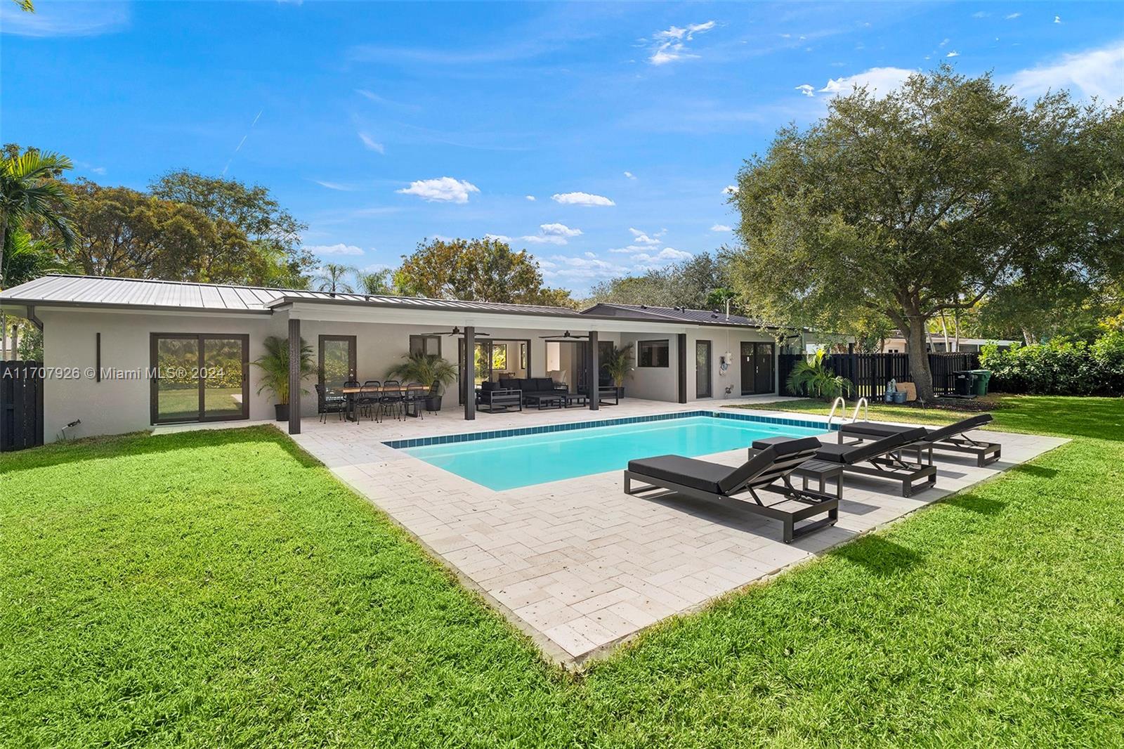 Discover this fully remodeled masterpiece w 1,971 SQ FT UNDER AC in Pinecrest! Everything is NEW: roof (10-year wty), electrical, plumbing, insulation, impact windows, modern bathrooms, kitchen w new Samsung appliances, & thoughtfully designed floor plan. Situated on a spacious 16,770 sq ft lot, steps from Palmetto's top-rated schools. The home features a modern living/dining area w covered terrace access, luxurious master suite with built-in walk-in closet, junior suite w private bathroom & walk in closet w garden views, & 2 Jack & Jill bedrooms (1 of the bedrooms is currently open to the living room and could be used as a office or tv room). Lush landscaping, irrigation system, & carport for 2 cars. Move into high-end living without the hassle of construction—an unparalleled opportunity.