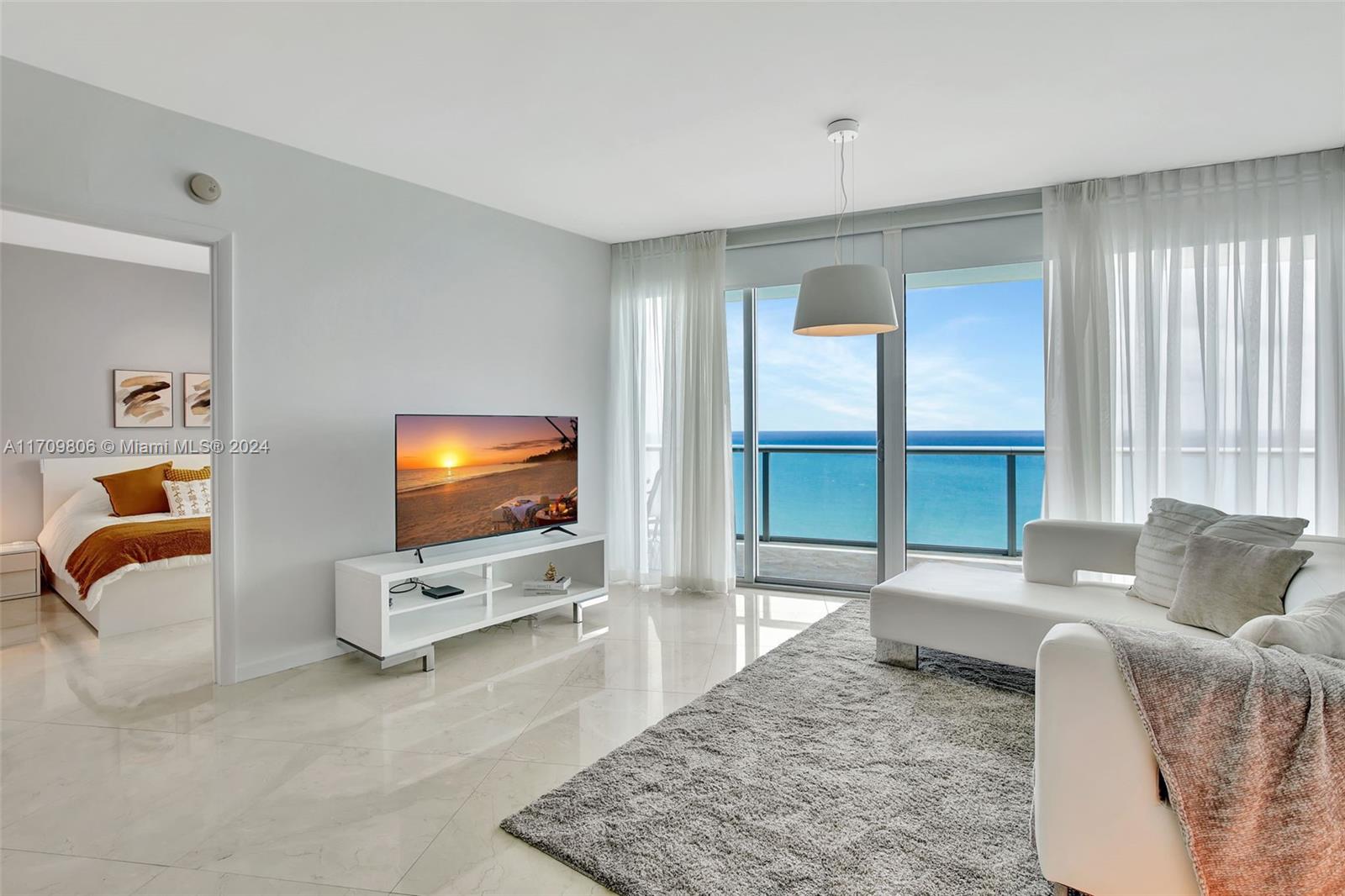 Experience luxury living in this stunning oceanfront condo at Jade Beach on the 37th floor. This fully furnished 2-bedroom + den, 3-bathroom unit features a private foyer entrance with direct elevator access, a spacious balcony with unobstructed ocean views from every bedroom, and high-end finishes, including quartz countertops, Snaidero cabinets, Miele appliances, a Sub-Zero refrigerator, electric blackout shades and more. Jade Beach offers premier amenities such as a world-class spa, massage room, two pools, a state-of-the-art gym, an on-site restaurant, and direct beach access. Conveniently located on Collins Avenue, it is minutes from Aventura Mall, Bal Harbour Shops, and Miami's finest dining. Don’t miss the opportunity to live in one of the most desirable beachfront locations!