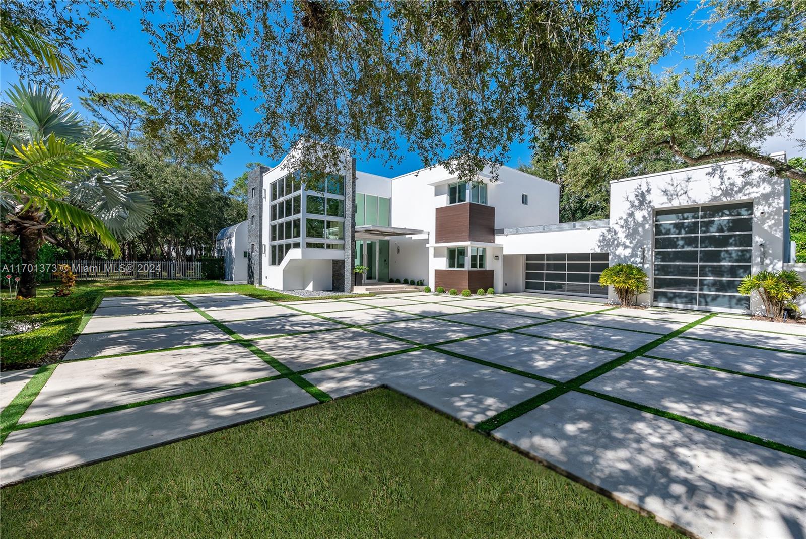 Modernism meets sophistication in Pinecrest. Step into a stunning architectural home by renowned architect Ralph Puig. 7,708 SF, this two-story with timeless design offers a seamless blend of comfort & convenience. The floor plan is perfect for entertaining & everyday living, with spacious living areas, office space, 2 ensuite bedrooms on 1st floor. Upstairs, 5 additional ensuite bedrooms. A chef’s paradise - a gourmet kitchen designed by Dada, with top-of-the-line appliances: Wolf gas range, Sub-Zero fridge/freezer & Sub-Zero wine fridge. For effortless living, an elevator provides easy access to both floors, while the 3-car garage, with space for a lift, caters to car enthusiasts. Step outside to a saltwater pool & jacuzzi. Discover modern living at its finest. Schedule your private tour