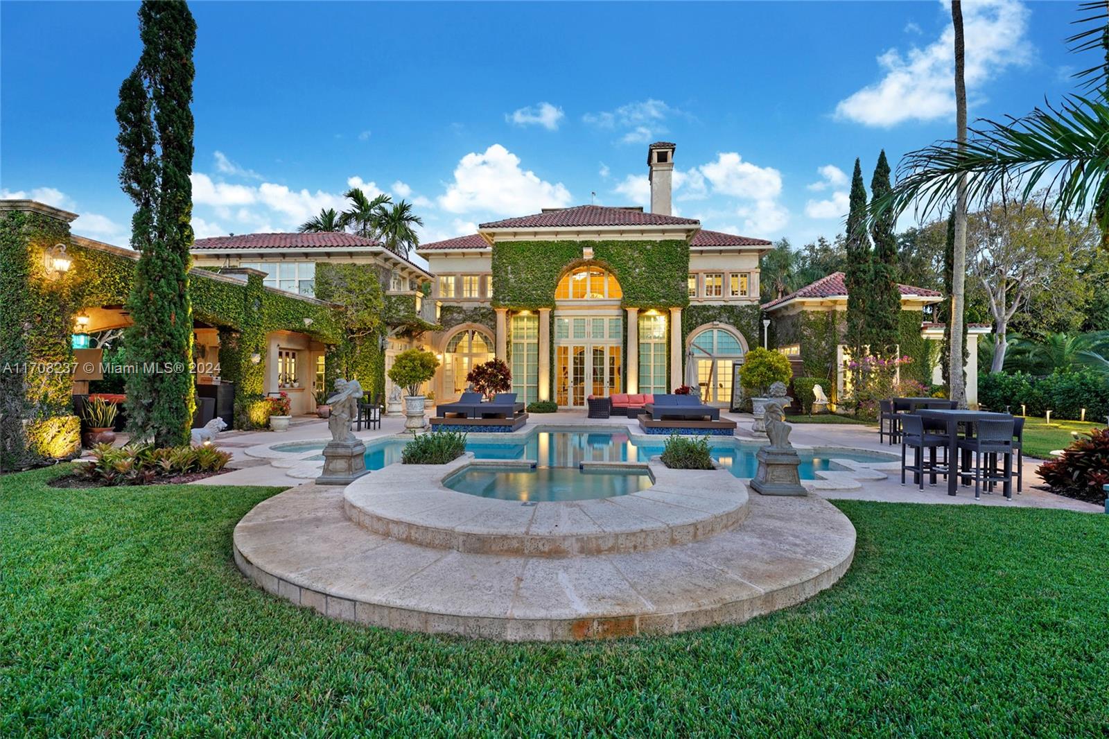 Showcase estate offering privacy and grandeur. A long, picturesque drive leading to a European-inspired home. The entry foyer welcomes you with tall windows, and a striking double staircase. The expansive formal living room boasts soaring 35-foot ceilings, a double-height stone fireplace, and panoramic views of the patio, pool, and meticulously landscaped gardens. The master suite is a private retreat, featuring a glass atrium and a cozy sitting room. The family room opens to a spacious covered terrace with wood beams, perfect for entertaining. The outdoor features a picturesque pool and spa, covered BBQ complete with lots of seating for outdoor enjoyment. A must see to appreciate.