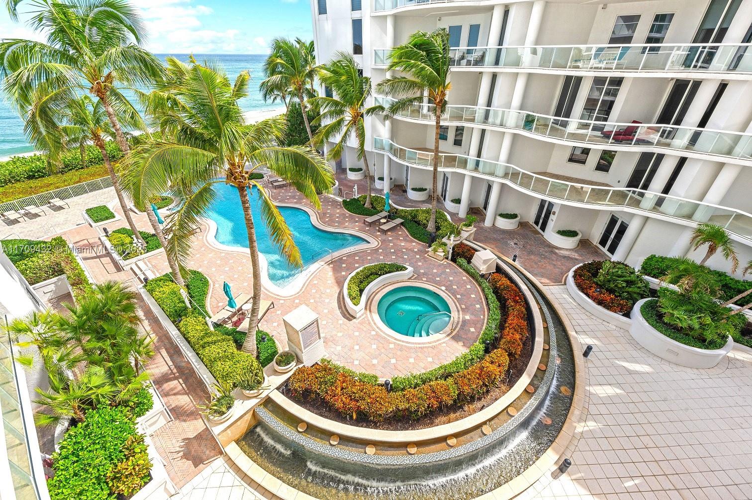 Only a Penthouse & this ground floor condo have 12'6" high ceilings & 10 foot tall hurricane impact sliding doors.  Walk out your door to the pool, beach, grill area & a patio with ocean views.  Hurricane building codes updated in 2005 & this condo was built in 2007.  Doorman building with a security gate & 2 garage parking spaces (#60 & #61).  Amenities include a social room, resort style pool, hot tub, fitness center, sauna, movie theater & 2 outdoor grill areas.  Paint & building repairs completed in 2020 & Beach Front is lender approved.  2 dogs up to 25lbs with a dog run on the south side.  Two AC Units installed June 2021.  AC cooling tower on the roof is maintained by the condo assoc.   Storage locker too!