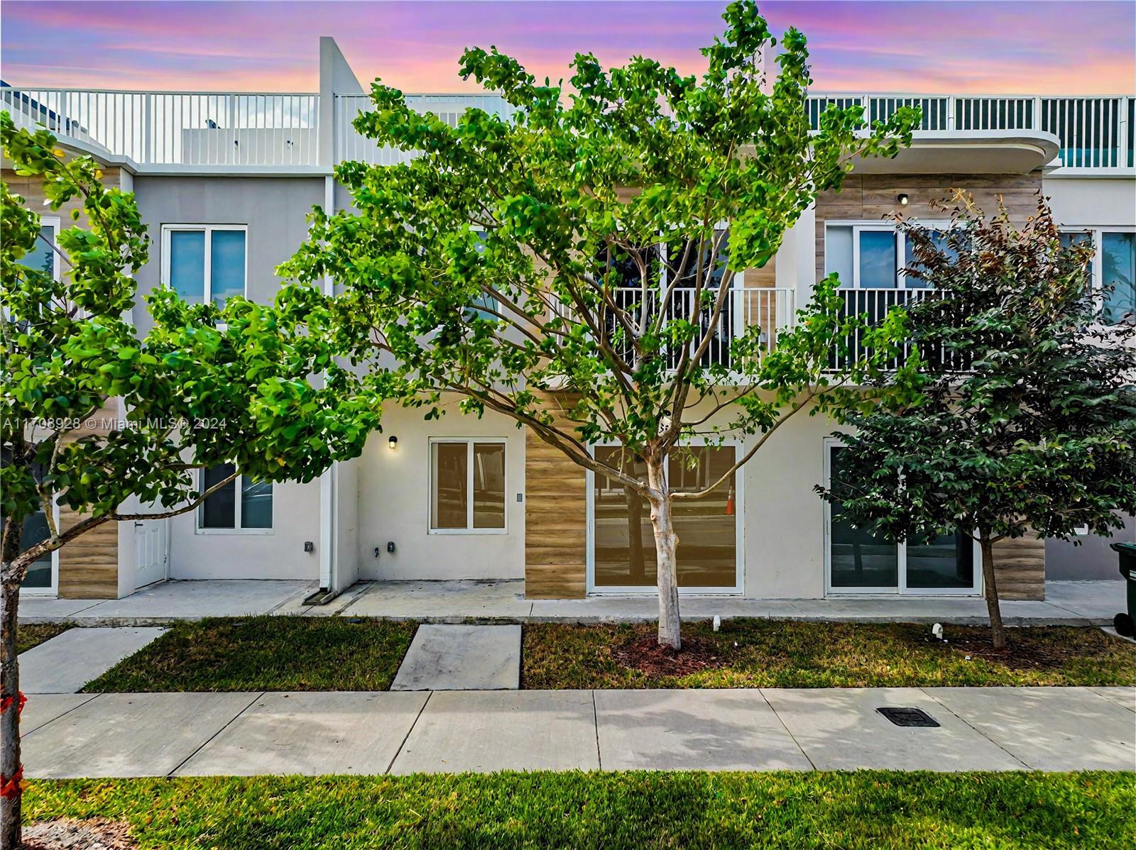 Brand-new two-story townhome featuring four bedrooms, three full and  1 half bathrooms, and a rooftop terrace perfect for entertaining or relaxing. A concrete home with an open floor plan that connects the living, dining, and kitchen with quartz countertops and stainless steel appliances. Downstairs includes a bedroom with a full bathroom and with its own entrance. Upstairs, the primary bedroom offers a full bathroom, walk-in closet, and balcony, along with two additional bedrooms, a full bathroom, and a laundry room. High-end finishes, impact windows, and brand-new appliances, including a washer and dryer, complete this home. Enjoy amenities such as a playground, BBQ area, dog park, and visitor parking near great schools, parks, and shops. Enjoy the 3D tour! May the Force be with you!