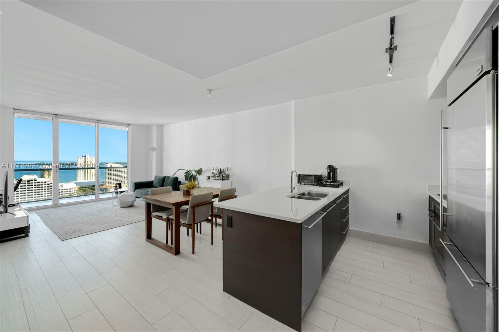 AVAILABLE JAN 15th. A spacious & bright 1-Bed condo at 500 Brickell East featuring porcelain tiled floors throughout, stainless steel kitchen appliances, in-unit washer/dryer, blackout shades in bedroom/solar shades in living room, his & hers bathroom vanities, a glass-enclosed shower & separate tub, spacious walk-in closet, and floor-to-ceiling windows w/ direct views of Biscayne Bay & the city skyline from the 28th floor. Building amenities: a rooftop sundeck w/ heated pool, an infinity-edge pool on the 11th floor, his & hers sauna and steam rooms, fitness center, theater, club room, sports room w/ billiards table & kitchen, and 24-hour concierge & valet parking. 1 block from the shops, restaurants, and entertainment at Brickell City Centre.