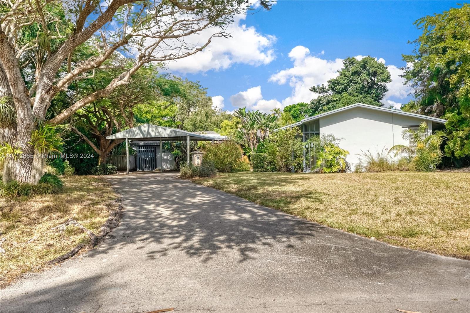 Excellent opportunity to make this Pinecrest corner lot home yours! Built in 1975, it features four bedrooms and three bathrooms, boasts two master suites, a pool, on a large corner lot on a quiet street. The home was artificially elevated from the street when built to all but eliminate any chance of flooding by design. The living room and family room are open and create an enormous open space. The primary Master bedroom is very large and boasts an equally large master bathroom with his and hers sinks and toilets. Opposite side of the home are three bedrooms, two sharing a bathroom and one with its own en suite bathroom. The fenced backyard boasts a large patio, Chiki Hut, shed and garden. The property is covered in trees and other exotic plants and parking couldn't be easier.