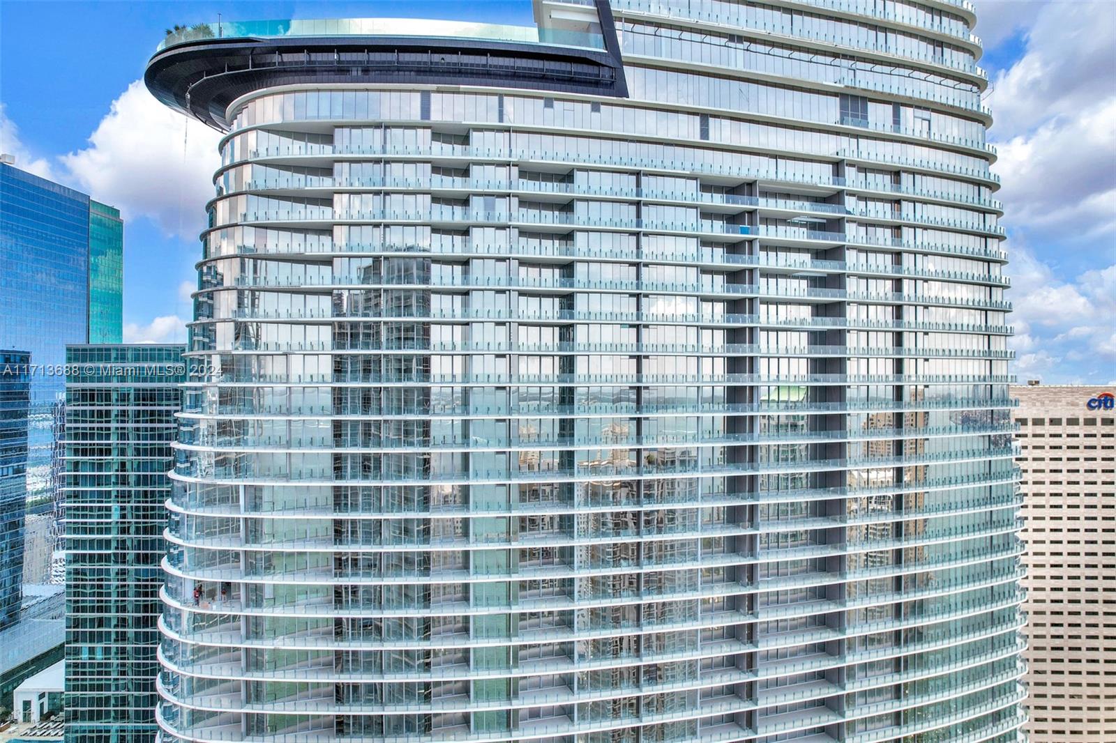 Discover luxury living in this exceptional 3-bedroom + den, 4.5-bathroom residence on the 43rd floor of the newly completed Aston Martin Residences in Downtown Miami. With breathtaking panoramic views of Biscayne Bay and the city skyline, this flow-through unit offers seamless living and dining spaces. The gourmet kitchen is outfitted with top-tier Gaggenau appliances, while the separate staff quarters feature a full bathroom and laundry area. The expansive layout includes a family room, living room, and den, perfect for both relaxation and entertaining. Residents enjoy exclusive access to world-class amenities, including indoor and outdoor pools, a two-story fitness center, spa, golf simulator, art gallery, and more, all in the heart of Miami’s vibrant downtown.