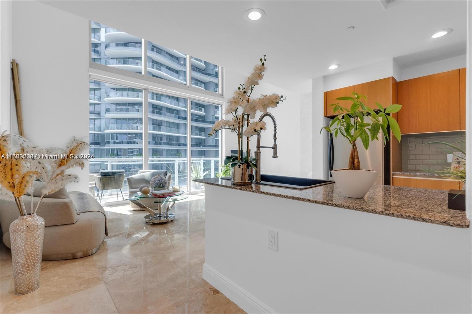 Welcome to your dream LOFT in the heart of Brickell! This spacious 1,128 sq ft gem is located on the 24th floor and features a cozy bedroom on the second level, a full bath, and a convenient half bath on the first floor. You'll love the open floor plan, which boasts impressive 20-foot-high ceilings and large windows that face West, offering breathtaking views of the Brickell skyline and those gorgeous sunsets. The kitchen is a chef's delight, with stylish Italian-designed cabinets and beautiful granite countertops. This loft comes packed with upgrades, including stunning floors, remodeled bathrooms, modern lighting, charming wall decorations, and electric shades to add a touch of convenience. Assigned parking space. Minutes from Key Biscayne, Coconut Grove, and Coral Gables.