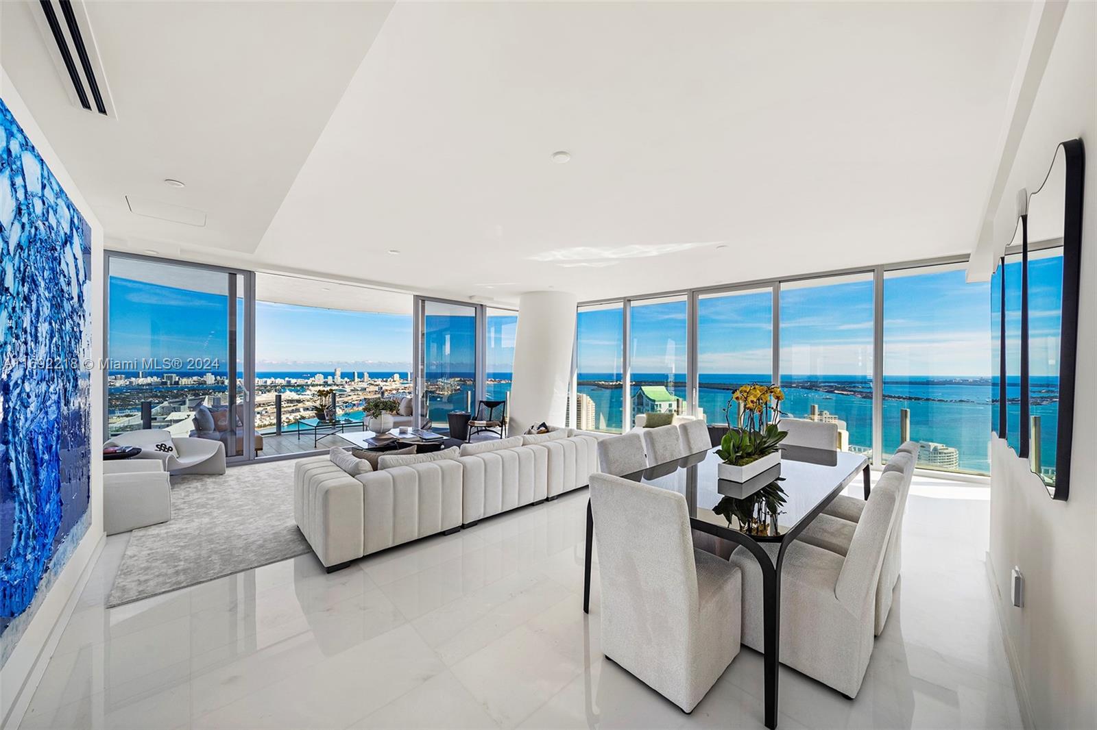 Sky Residence #4701 rises above neighboring buildings offering unobstructed private panoramic views of the beach, bay and city from every room. This signature 01 line has over 3700 sq ft with 5 bed/5.5 bath, laundry room, marble floors, Bulthaup Kitchen, Gaggenau Appliances. The 2 large terraces are perfect for entertaining with floor to ceiling glass. A high-speed elevator from the Exclusive East Lobby opens into your private foyer leading to the wide gallery hallway perfect for Art Collectors. Over 42,000 sq ft of world class amenities, state of the art fitness center, luxury spa, infinity pool, cabanas, lounges, 2 theaters, playroom - too many to list! Parking includes 2 side by side spaces near the elevator, plus valet. World class shopping, dining and the bay walk are close by