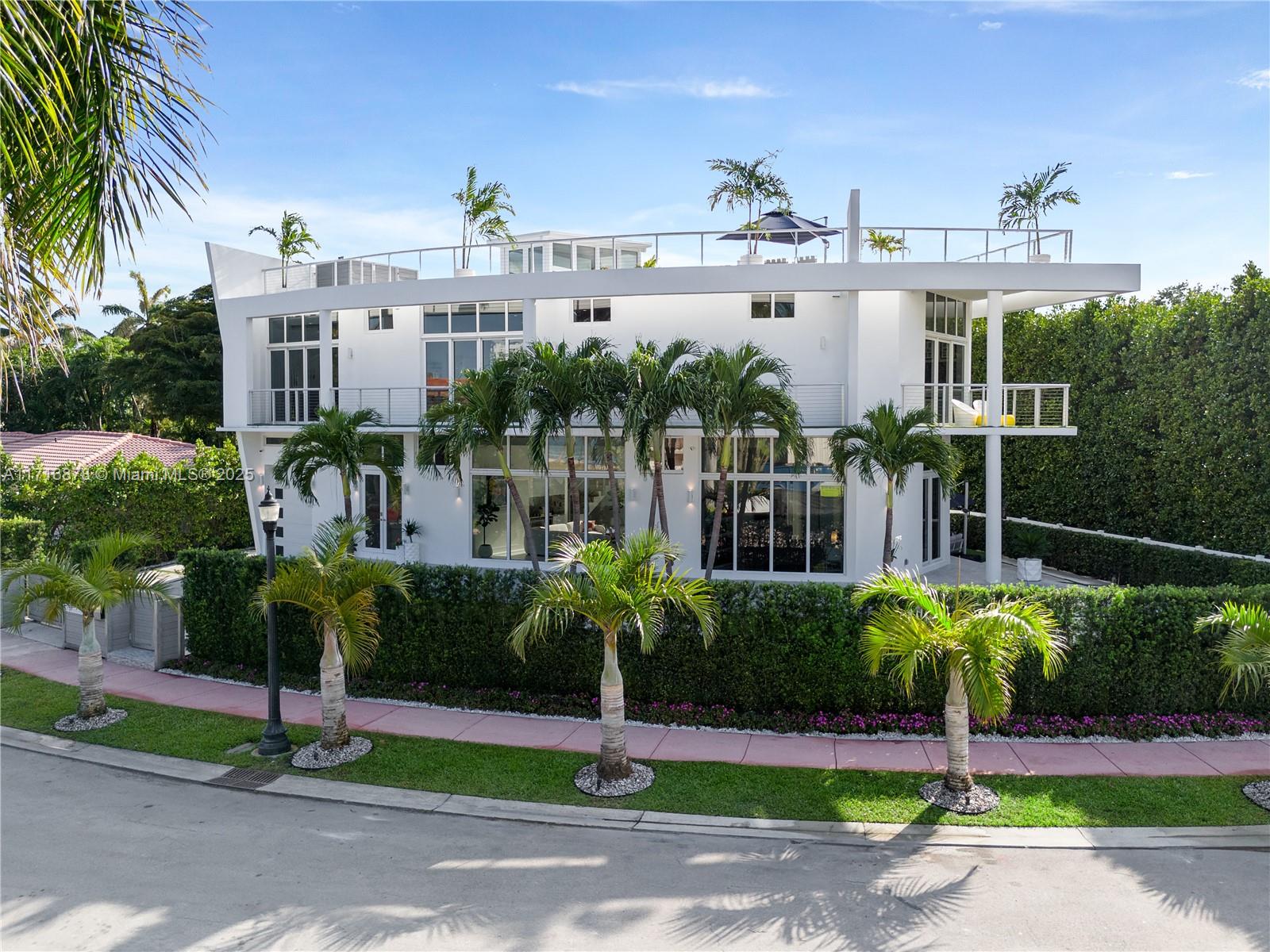 Casa Sails is a stunning fusion of modern design and serene luxury in Miami Beach’s exclusive Venetian Islands. Elevated 10 feet & spanning 5,860 total SF, this 5-bedroom, 5.5-bath home boasts sleek, sailboat-inspired architecture and light-filled interiors framed by nearly 100 UV-protected windows. The open layout is enhanced by smart-home technology & a premium sound system. A private backyard with a sparkling pool offers tranquility, space for up to 5 cars with two extended driveways and a garage provide convenience. Safety is assured with dedicated police patrols & 24/7 cameras. The 1,800sqft rooftop crowns this masterpiece, offering breathtaking 360-degree views of Biscayne Bay, sunrises, and sunsets. Walking distance to The Standard. Explore the virtual tour or book a showing today!