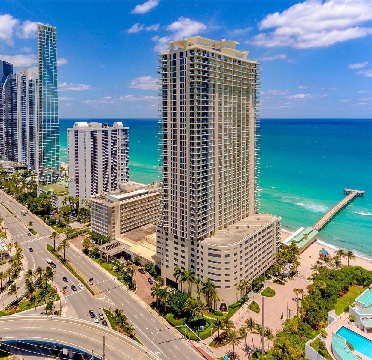 Corner unit with a great location and views in Sunny Isles, easy access to roadways. Building amenities include high-tech fitness center with spa, 24 hour valet, business center, party room, billiard room, heated pool, and full beach service. Unit has open floorplan with marble floors, two split bedrooms with one en suite and second bathroom with access for guests. Floor to ceiling windows throughout. Full capacity washer and dryer in a separate closet. Walk in closet in primary bedroom and an owner's closet. Primary bathroom has double sinks with separate shower and tub. Italian cabinetry and granite countertops in kitchen. Large wrap around balcony with ocean and city views. Fully furnished, can be rented monthly.