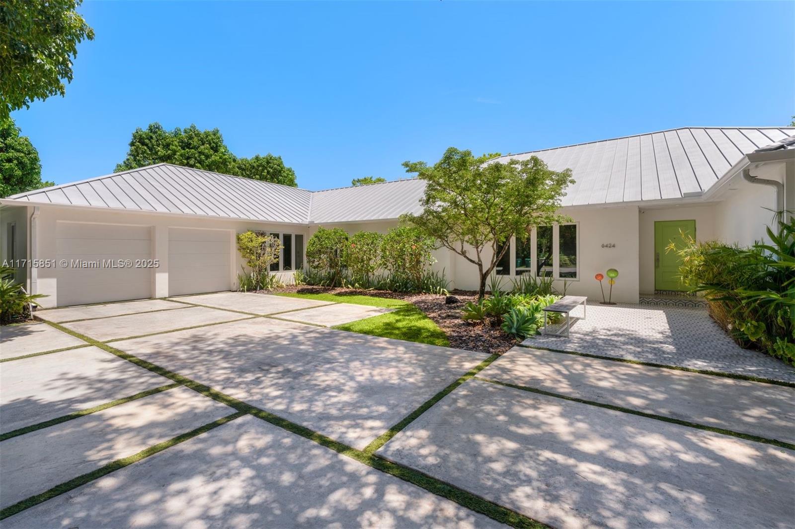 Beautifully renovated 5-bedroom, 4.5-bathroom 6,687 SF home on a spacious lot and quiet tree-lined street in Pinecrest. The residence exudes tremendous curb appeal, and an open layout and vaulted ceilings provide lots of natural light. The impressive eat-in kitchen features custom floor-to-ceiling cabinetry, high-end Wolf and Sub Zero appliances, gas range, large pantry, and an expansive center island with seating and storage spaces. The interior seamlessly connects to outdoor entertainment areas, a spacious covered patio, barbecue, pool, jacuzzi, and plenty of green space. Additional features include impact windows and doors, whole house generator, gym, two offices, ample parking with two garages, and a metal roof.