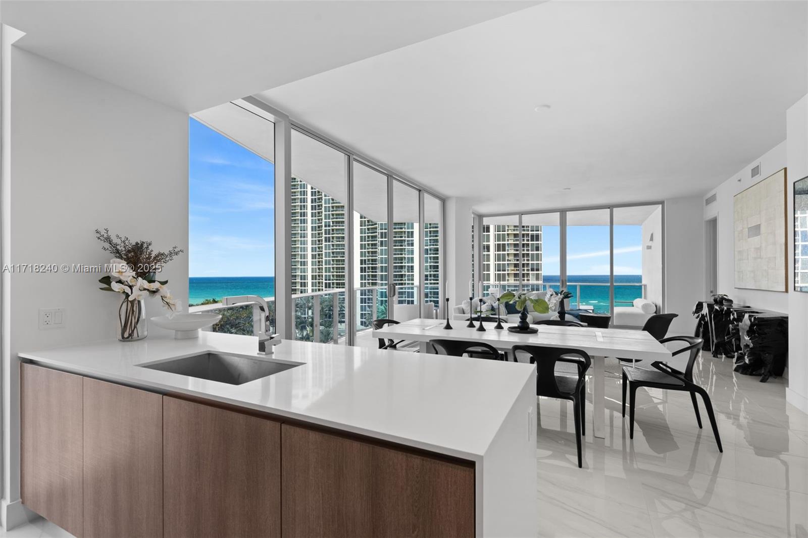 Experience the pinnacle of modern luxury living at Aurora Sunny Isles, just minutes away from the Atlantic Ocean. This sleek boutique building redefines seaside elegance, blending sophistication and comfort seamlessly. Retreat to this 2-bed, 2.5-bath corner unit, boasting a private terrace with panoramic ocean vistas. Elevate your living experience by owning the only line available with a private elevator, reveling in contemporary opulence with 10-foot floor to ceiling windows throughout. Entertain with the chef-inspired kitchen, equipped with Wolf and Sub-zero appliances, where culinary delights are crafted amidst a backdrop of panoramic ocean views. Enjoy resort-quality amenities, including a lush pool deck, state-of-the-art gym, Turkish hammam, and children play area for entertainment.