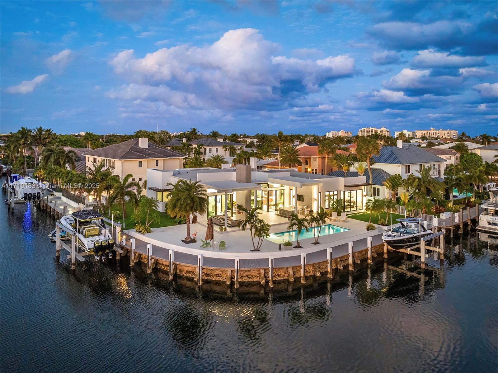 Experience the epitome of luxury in this brand-new modern ranch-style home built by renowned Zahn builders, positioned perfectly on a coveted point lot in Lighthouse Point. Boasting over 200' of prime water-frontage on the South Grand Canal, this gem is just minutes from the ocean. Revel in the meticulous design with 3 primary sized bedrooms, 4.5 lavish baths, a state-of-the-art gym, and an expansive 4-car garage. The open-concept interior showcases no-expense-spared finishes, including mesmerizing backlit onyx countertops and select materials that exude opulence. A rare offering, this home is the embodiment of sophisticated living.