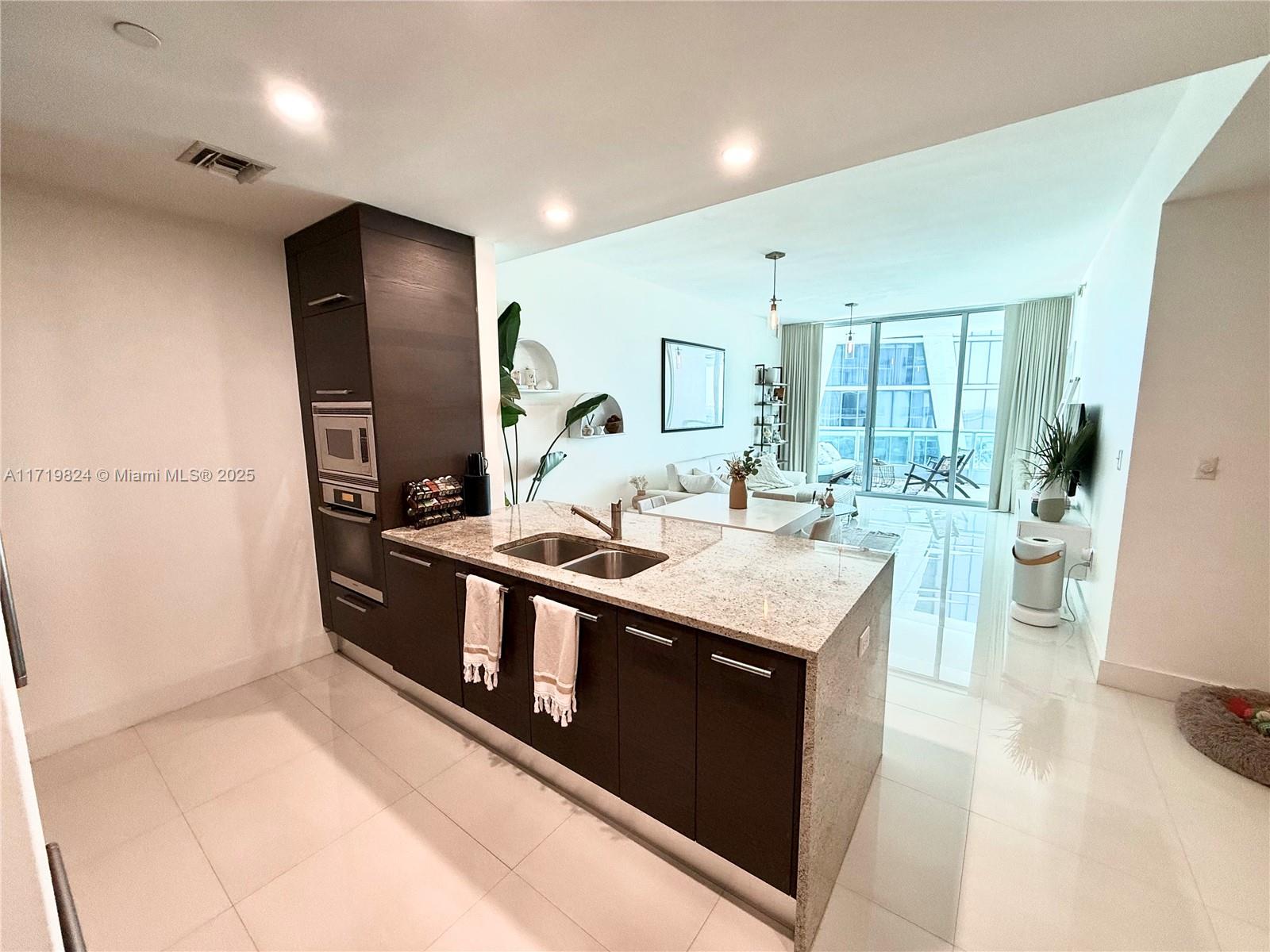 Discover modern elegance in this 1,031 sq. ft. furnished residence at the iconic 900 Biscayne Bay. The spacious primary suite features an open walk-in closet and motorized curtains/blackouts. The versatile den easily converts into a second bedroom, office, or study. Enjoy a sleek open kitchen with premium appliances, two luxurious full baths, and seamless indoor-outdoor living with two private balconies offering stunning city and bay views. This unit includes 1 assigned parking space. 900 Biscayne Bay offers world-class amenities: 2 gyms, spa, pools, theater room, business center, and 24/7 concierge services. Pets are welcome. Schedule your tour today!