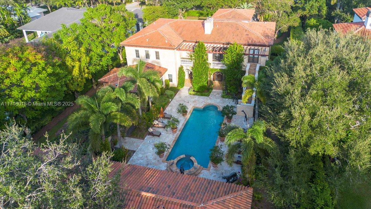 Welcome to “Lake Como in Miami,” an enchanting sanctuary on coveted W. Suburban in N. Pinecrest. 9BD/7.5BA/4-car villa seamlessly fuses traditional & modern design, featuring a dramatic entrance, soaring ceilings, and a 1920’s theater. A gourmet Wolf/SubZero kitchen, breakfast & family room, formal living, library, game room & 2,000-bottle wine cellar set the stage for luxurious living. 4 bedrooms downstairs (3 currently used as offices/game room) complement a lavish primary wing with spa bath and huge walk-in closets, plus 4 more en-suite bedrooms upstairs. Embrace resort-style indoor/outdoor living with a pool, spa, expansive terraces, built-in summer kitchen, gardens, putting green, gazebo, and guest house. Crestron, impact glass,  generator, & elevator complete this remarkable retreat.