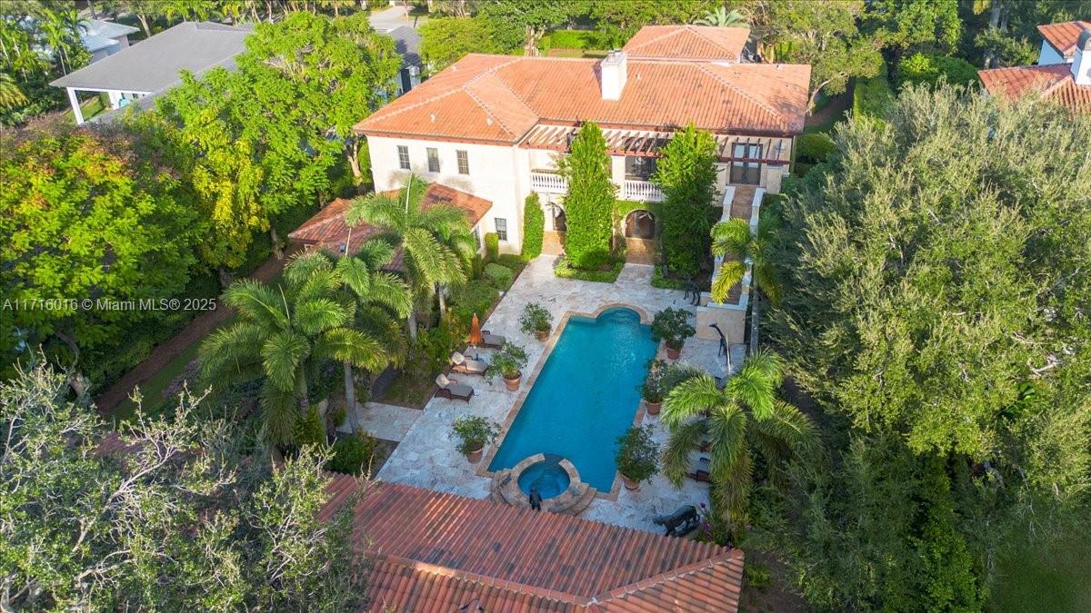 Welcome to “Lake Como in Miami,” an enchanting sanctuary on coveted W. Suburban in N. Pinecrest. 9BD/7.5BA/4-car villa seamlessly fuses traditional & modern design, featuring a dramatic entrance, soaring ceilings, and a 1920’s theater. A gourmet Wolf/SubZero kitchen, breakfast & family room, formal living, library, game room & 2,000-bottle wine cellar set the stage for luxurious living. 3 bedrooms downstairs (2 currently office/game room) complement a lavish primary wing with spa bath and huge walk-in closets; 4 more  bedrooms upstairs. 2nd office. Embrace resort-style indoor/outdoor living with a pool, spa, expansive terraces, built-in summer kitchen, gardens, putting green, gazebo, and guest house. Crestron, impact glass,  generator, & elevator complete this remarkable retreat.