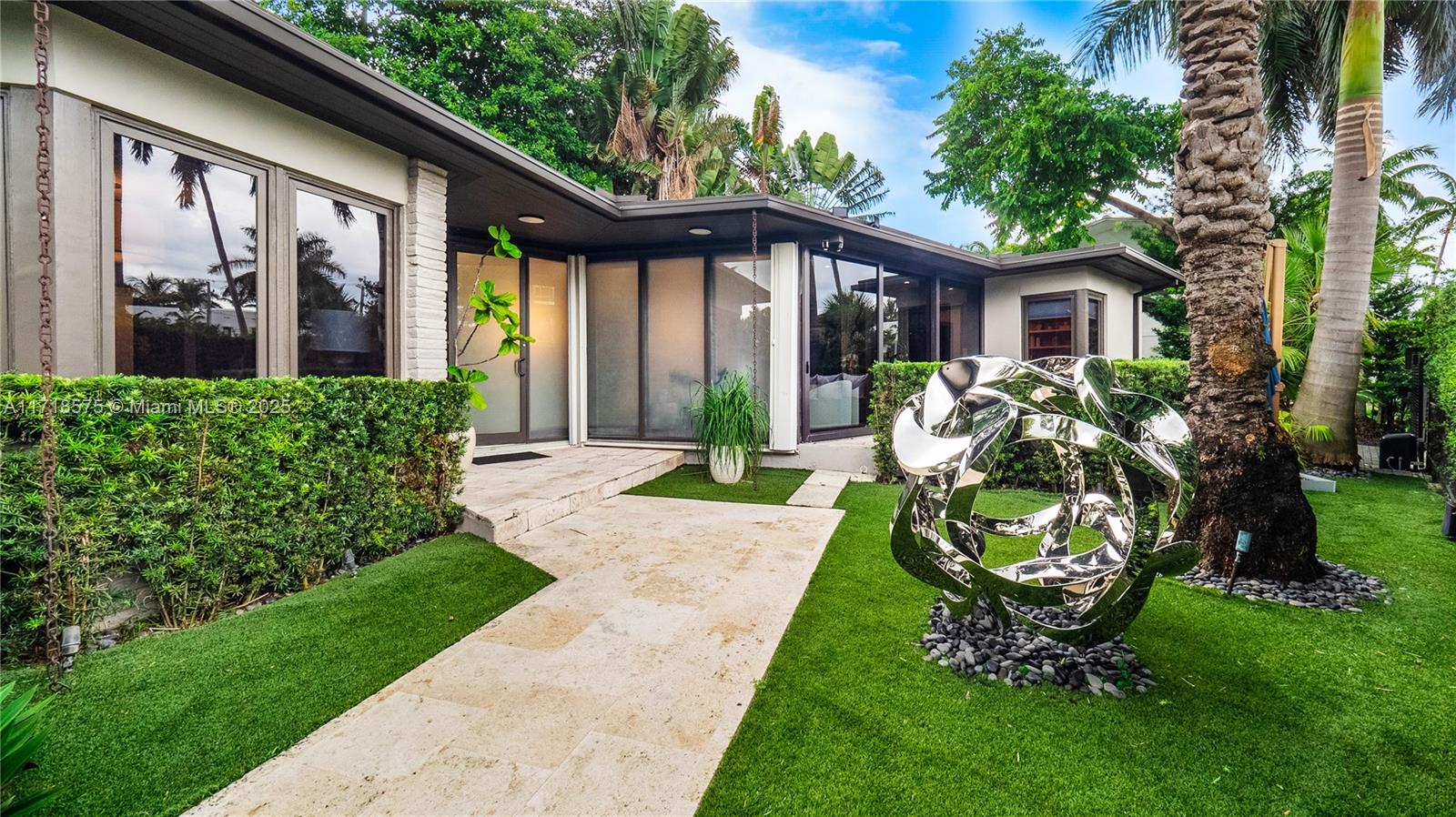 A tropical retreat on the highly sought-after Venetian Islands presents a stunning 3-bedroom residence with a den, all on one level. This corner-lot home offers an exquisite private setting, with a beautifully landscaped garden and pool ideal for tranquil poolside lounging. Enclosed by a secure, private fence, this home has been impeccably updated by NMR Design Group, featuring a brand-new kitchen with sleek Italian cabinetry, Caesar stone waterfall countertops, and top-of-the-line Sub-Zero and Wolf appliances. Porcelain floors grace the bedrooms, while original terrazzo flooring complements the living spaces, opening onto an outdoor deck with custom-built seating. Ideally located near Lincoln Road and Sunset. This property defines modern luxury and prime location on the Venetian Islands.