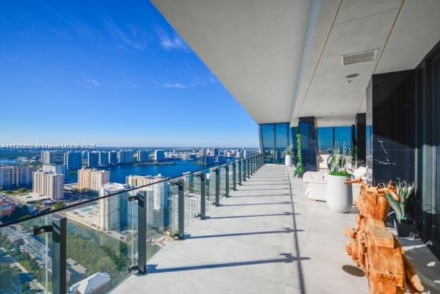 Enjoy unobstructed City, Intracoastal, and some ocean views from this high-floor corner residence in Muse Sunny Isles Beach. This remodeled with designer finishes 2 bed and 2,5 bath smart home unit with private foyer entry, 12’ ceilings, and gourmet kitchen. The floor plan was improved by expanding the living room, Italian porcelain floors throughout, bubble water panel with LED lights, handcrafted onyx in the guest bathroom, bamboo wallpapers, black marble slabs give the elegant covering of the columns at the balcony, and Italian doors. Large outdoor living space w/summer kitchen. With only 63 ultra-luxury exclusive residences Designed by Carlos Ott, an edge pool and spa overlooking the Atlantic Ocean, a State-of-the-art fitness center, and a Fully automated parking system.