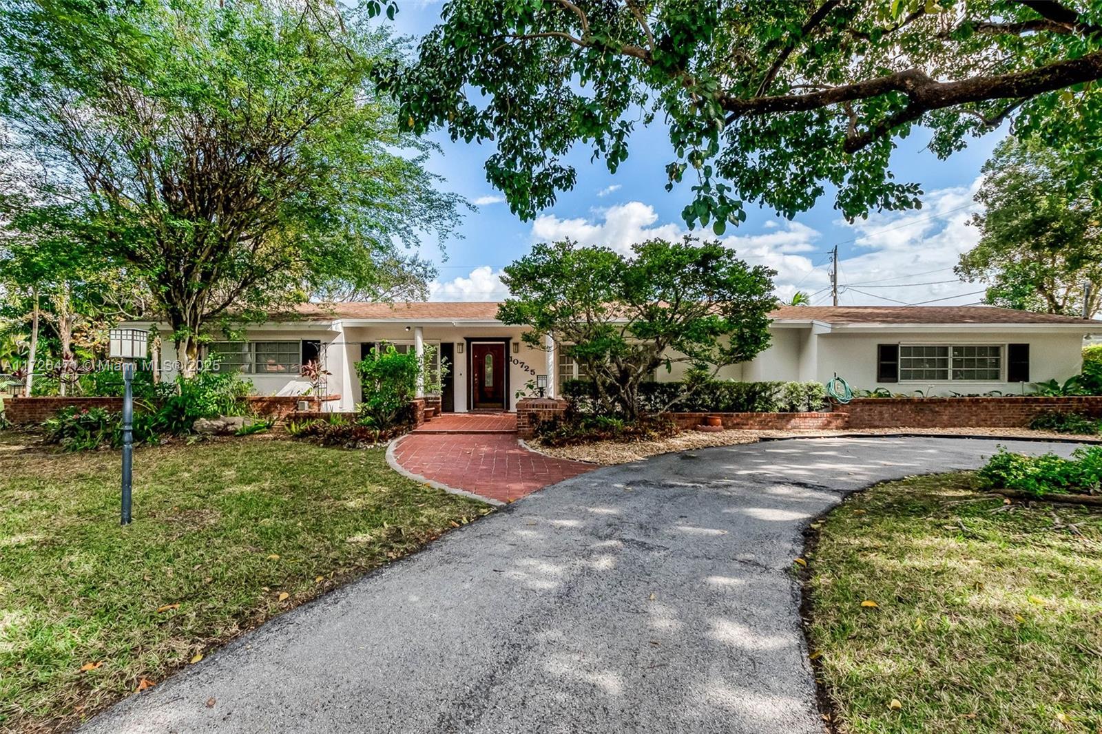 Beloved, spacious 5 bedroom/ 4.5 bath home in North Pinecrest, ready for your updates. Enter the formal living room with polished, original terrazzo floors and delightful view of the backyard from a wall of French doors. Grand formal dining room with china closet. Kitchen has eat in table, wood cabinetry and granite countertops, double wall oven and pantry. Charming family room with wet bar, beautiful stone fireplace. Split floorplan with 3 guest bedrooms, one ensuite, with walk in closets. Private, grand primary suite with large bath and walk in closet. 5th bedroom also ensuite w/ private entrance, perfect for in-laws or guests. 2 newer AC units. Laundry room and several storage closets. Expansive, screened pool and patio, 2 sheds.