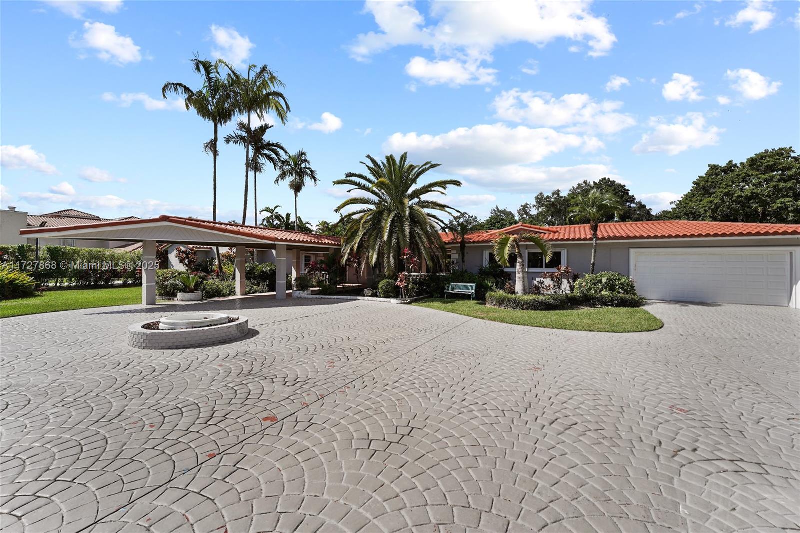 Located on a prime, gated 1.02-acre lot in the heart of Pinecrest, this sprawling 6,054 sqft ranch-style estate offers 5 bedrooms, 6.5 bathrooms, and a 2-car garage. Perfect for modern living, it features a 2017-renovated kitchen with stainless steel appliances and granite countertops, an open floor plan, and a serene master suite with an oversized walk-in closet and pool views. The beautifully landscaped grounds include fruit trees, a pond with a waterfall, and a sparkling pool, creating an idyllic outdoor retreat. Additional highlights include a second kitchen, a 65-kilowatt underground generator, and a newer roof installed in 2019. This property is ideal for end buyers, investors, or developers seeking to create their dream estate in a prime Pinecrest location.