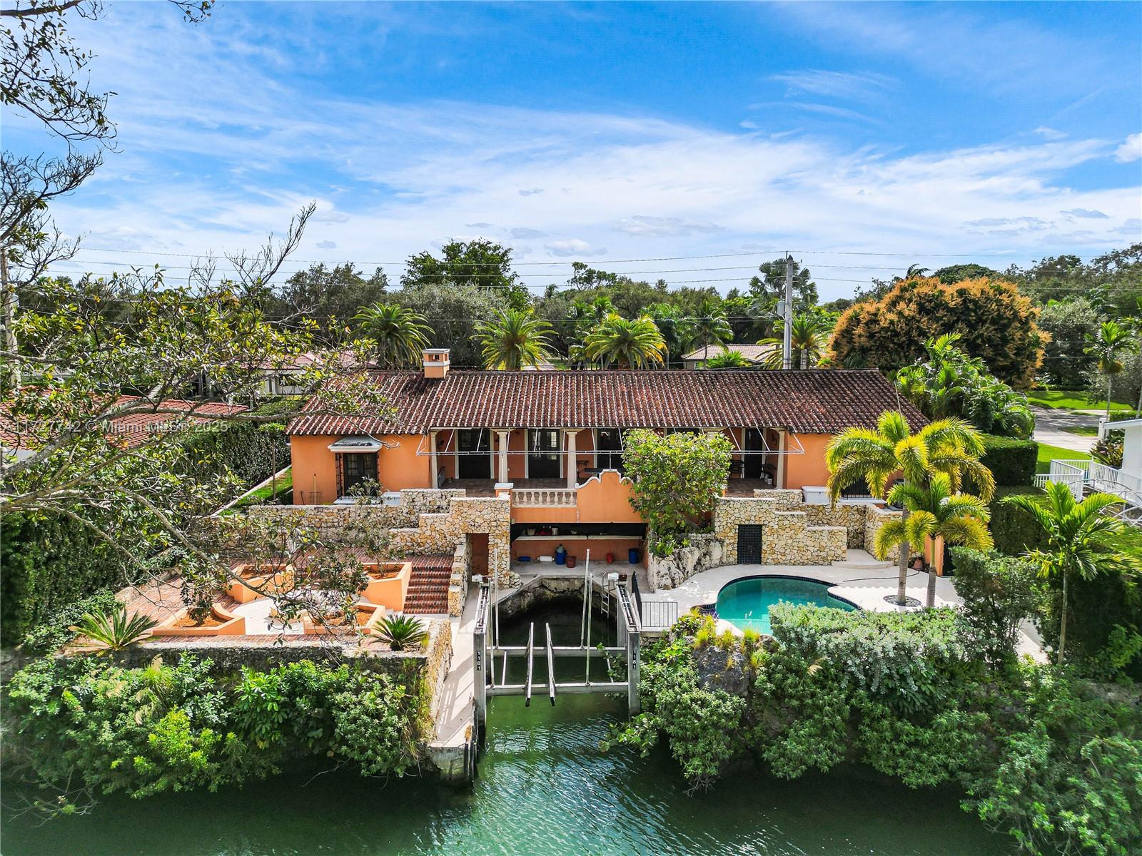 Waterfront Villa on the S. Gables Waterway.Boaters Dream or live on the water.Protected cove dock for the boat.First time on the market.Completely Walled and gated for privacy.Beautiful backyard overlooks the water,pool and picturesque gardens with pathways.Large covered terrace is great for outside entertainment overlooking the water.Built high up, the back yard has commanding views.All bedrooms have balconies that open to fresh air and views of the landscaping.Impact glass,Poggenpohl kitchen with Island and gas stove.Viking,Sub Zero and Miele appliances.Also wine cooler.Den,Very high cielings,fireplace,2 car garage. Newer AC-water heater.Walk to Sunset elementary school, bathrooms original.