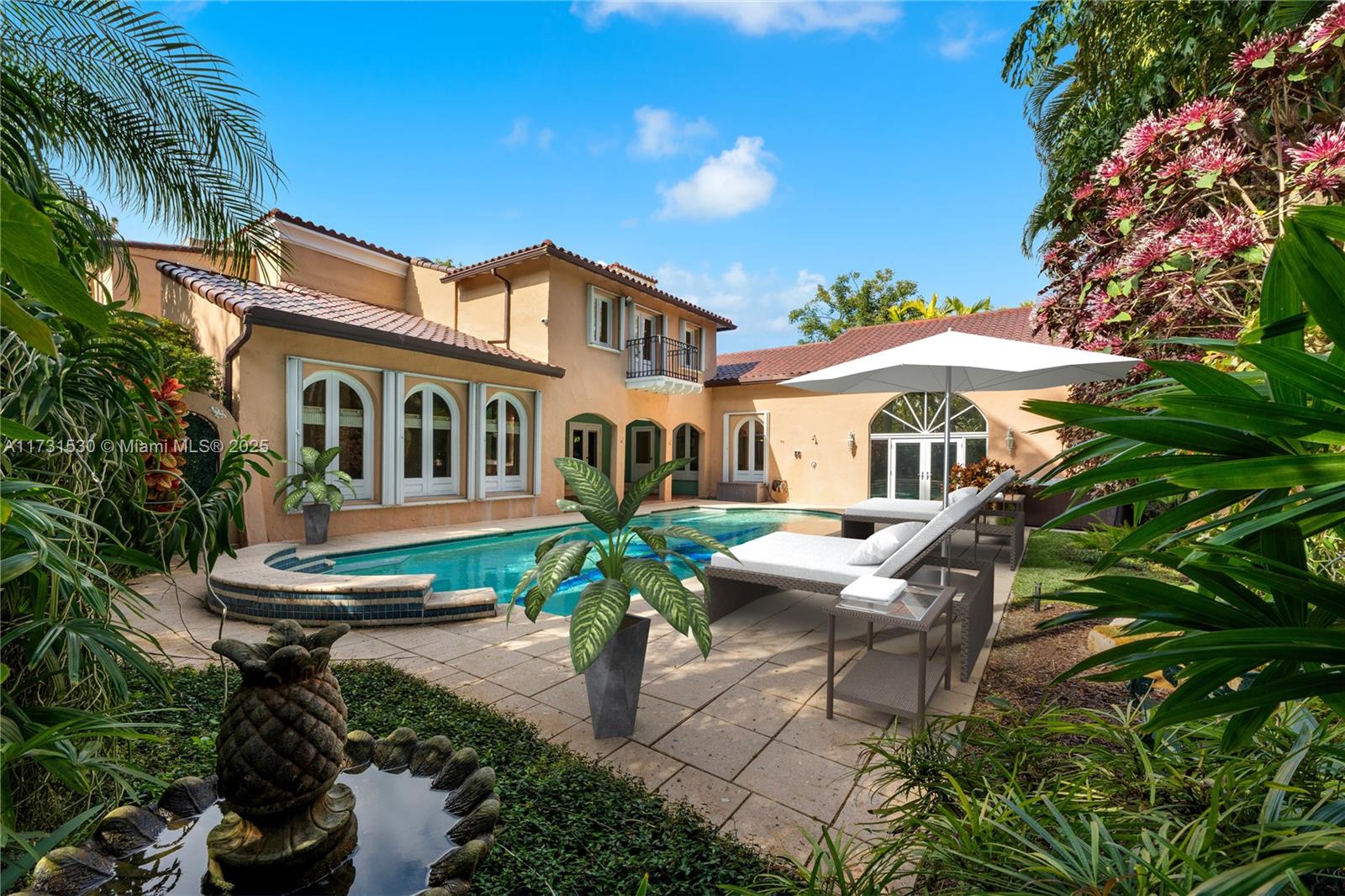 This iconic 1924 estate, set on a 10,219 SF lot with 5,113 SF of living area and 5,886 SF total, blends timeless elegance with modern sophistication. Restored to perfection, it features 5 bedrooms, 8 baths, a grand mahogany staircase, and a custom kitchen with black granite counters, premium appliances, and a breakfast area. The principal suite redefines luxury with dual spa-like bathrooms, walk-in closets, and a private sitting area. Outdoors, enjoy a sparkling pool, koi pond, waterfall, and lush tropical landscaping, perfect for relaxation or entertaining. Additional highlights include a bespoke wet bar, an enclosed gym, Spanish-tiled terraces, PVC piping, electric shutters, and exquisite craftsmanship throughout. The estate is a rare blend of historic charm and contemporary luxury.