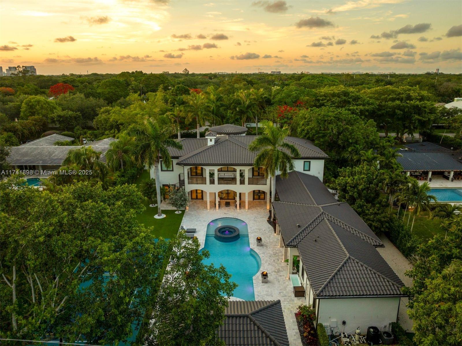 Located in a sought-after Pinecrest neighborhood with top-rated schools, this gated 7-bedroom, 8.5-bath estate is move-in ready and filled with standout amenities. The backyard features a saltwater pool, spa, cold plunge, sauna, gym, pickleball/basketball court, and a fully equipped summer kitchen, ideal for entertaining and everyday enjoyment. Inside, the open layout includes a chef’s kitchen with a striking L-shaped marble island, a formal dining room, and a living area with a fireplace. The ground-floor primary suite offers a private sitting room entry, dual walk-in closets, and a spa-inspired bath. Additional features include smart home technology, a three-car garage, and renovations throughout. Experience the privacy, space, and lifestyle this Pinecrest estate offers like no other.