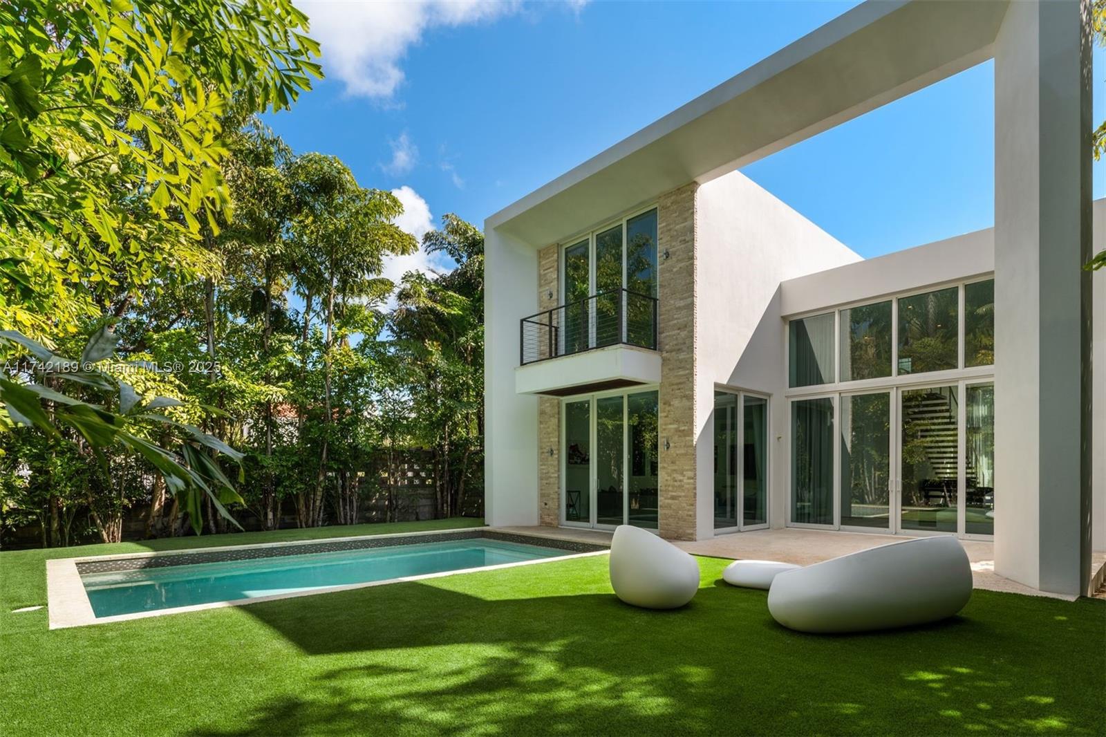 This exceptional two-story modern home offers 4 spacious bedrooms, 4.5 luxurious bathrooms, and 3,280 SQFT of meticulously designed living space on a generous 7,500 SQFT lot. Located in the heart of Miami Beach, this gated residence ensures ultimate privacy and tranquility. The home features a heated pool, a marble-clad master bath with a freestanding tub, and soaring double-height ceilings. Additional highlights include 2 laundry rooms, ensuring convenience and ease. Ideally situated on a quiet side street with limited traffic, the home offers the perfect blend of peaceful living and proximity to all the best that Miami Beach has to offer. Built by Todd Michael Glaser, this turn-key property exemplifies luxury, style, and sophistication.