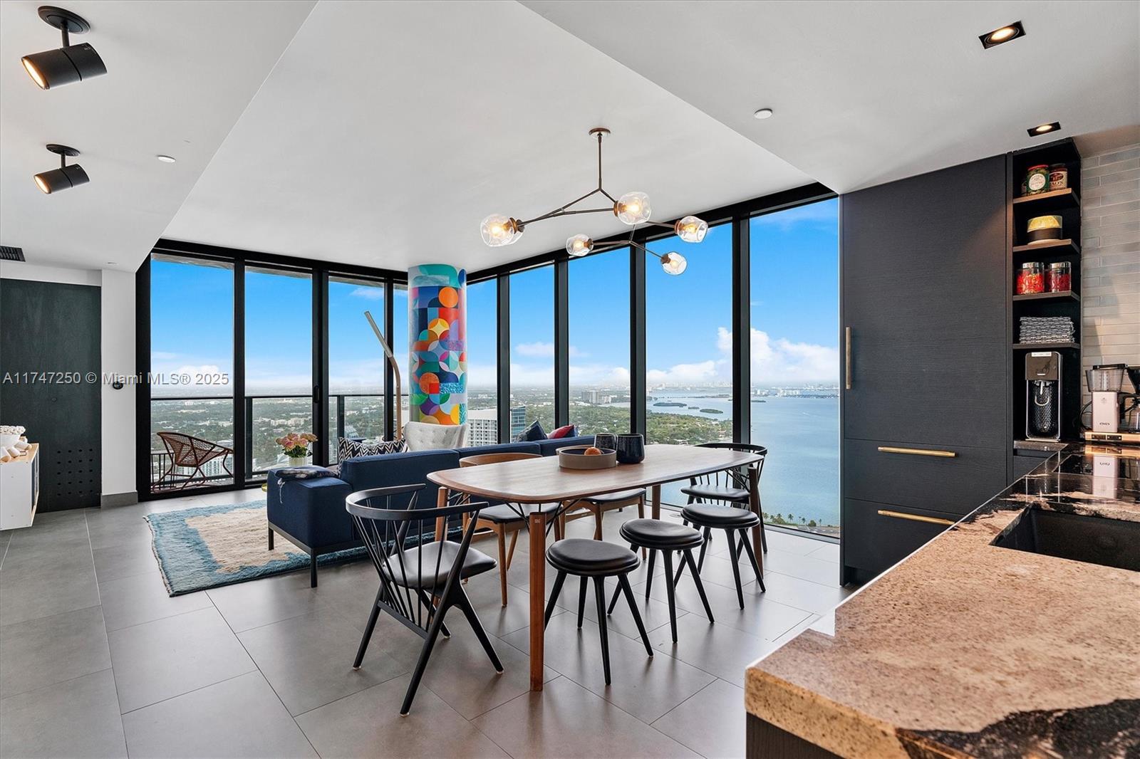 Over $150K of high-end, custom upgrades: Ann Sacks tilework, marble, and beautifully veined stone in the kitchen and baths, custom countertops, built-in desk, sculptural night tables, custom-painted column by artist Ronen Azulay, sleek Vitsœ bar, upgraded Wolf induction cooktop seamlessly integrated into countertop, Italkraft cabinetry, thoughtfully designed lighting throughout, fully built-out walk-in closet, storage niche in the primary shower stall, Brizo faucets in the kitchen, primary vanity, shower, and tub, Duravit sinks in both bathrooms (double in the full bath), Robern vanities in both bathrooms, Buster & Punch hinges and door handles, electric shades on all windows, and blackout shades in the bedroom.