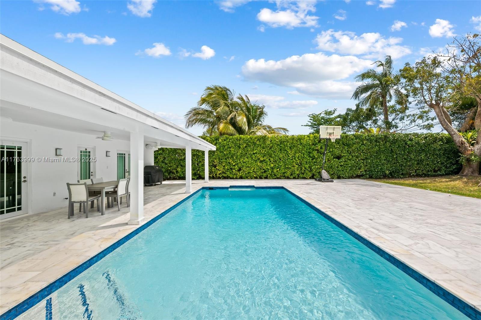 OVER $563K IN UPGRADES! This stunning 5-bed, 4-bath modern home offers 3,500 sq ft of luxury living on a 17,903 sq ft lot. The fully fenced backyard features an oversized pool with marble decking, perfect for entertaining. The renovated kitchen boasts Thermador appliances, a Kohler farmhouse sink, a waterfall quartz island, and white shaker cabinets. Enjoy peace of mind with IMPACT WINDOWS & DOORS, a NEW ROOF (2021), and an expanded primary suite. The desirable split floor plan, circular driveway, and extra parking add convenience. Top-rated schools! Minutes from Matheson Hammock Park, Downtown Miami, Brickell, The Beach & The Keys. A rare gem—schedule your private showing today!