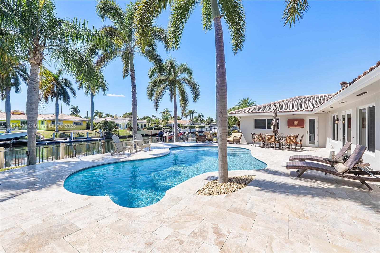 A Boater's Paradise near the Hillsboro Inlet. This immaculate 100ft waterfront home with ocean access is located in the unique coastal city of Lighthouse Point. The home flows with elegance and natural light. Enjoy the open plan living-dining area. Entertain in the expansive family and game room. All 4 bedrooms are airy and bright. Primary bedroom with en-suite is private and serene. Impact windows and doors throughout. For those cool nights enjoy the mid century modern fireplace. Cabana guest bath is ideal for your summer fun. Relish the Florida lifestyle outside. Repaved patio and pool resurfaced to entice all the senses. Newer dock with boat lift. Quick access to the beautiful beaches and 60 miles to the Grand Bahamas. Make your move to this exceptional home today!