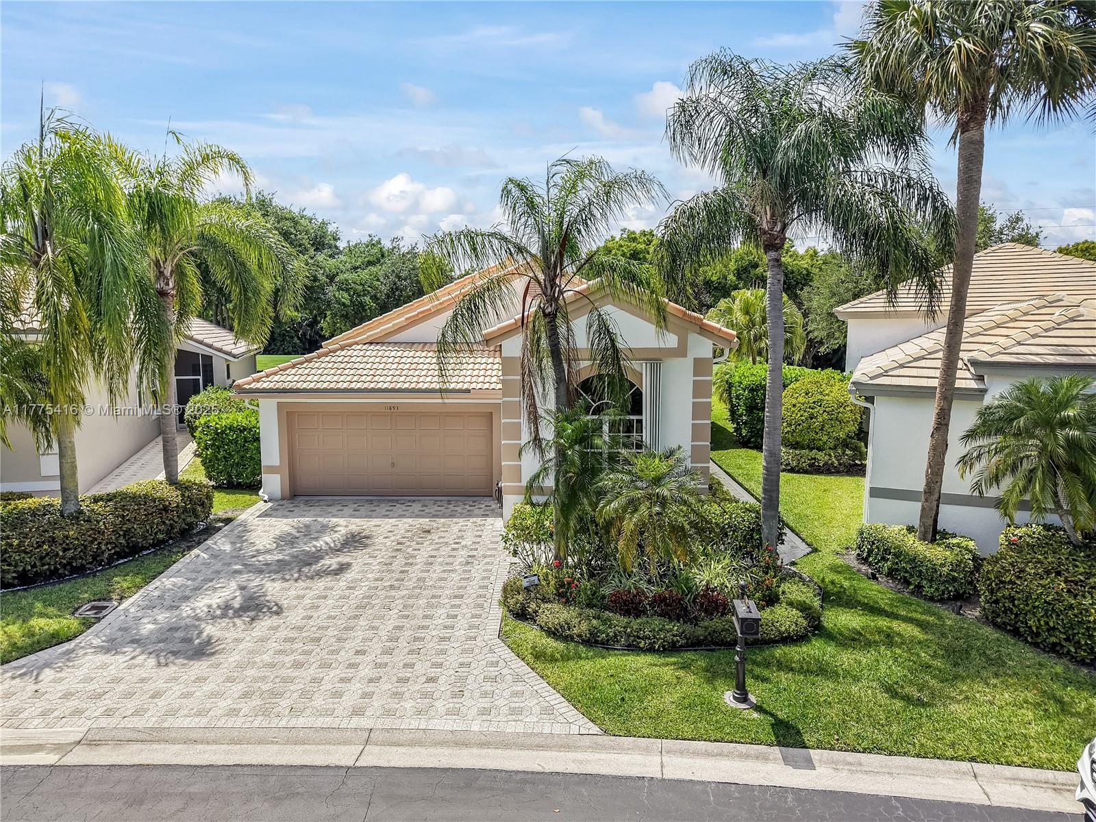 This beautifully updated 3 bedroom, 2.5 bath home is situated on the golf course, overlooking the scenic 16th tee. Featuring an expansive open floor plan with soaring vaulted ceilings, this home offers a bright and airy living space.The modern kitchen with 48" gray cabinetry, glass subway tile backsplash, quartz countertops, and stainless steel appliances. The home is equipped with hurricane accordion shutters and generator ready. White tile flooring throughout with laminate flooring in the master bedroom. The oversized master suite features a spacious walk-in closet with custom built-ins, and bathrooms have been fully renovated with sleek, modern finishes. Residents enjoy resort-style amenities, including a clubhouse, swimming pool, hot tub and clubroom. This is a guard gated community.