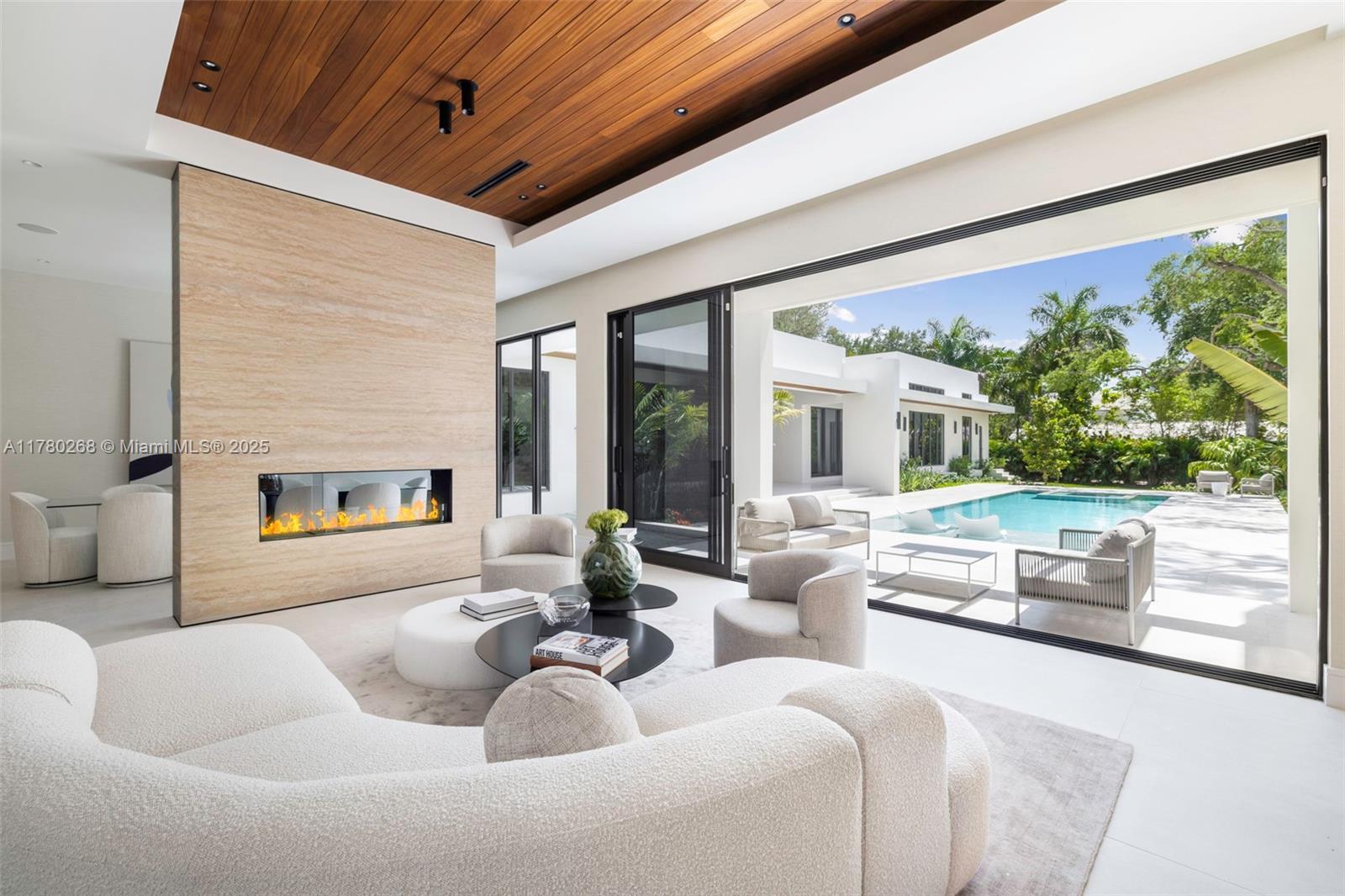 This brand new luxurious two-story corner residence features 7 bedrooms, 8 full bathrooms, and 2 powder rooms within a total of 11,557 Sq Ft, with 9,357 Sq Ft of living space, on a nearly-acre lot. It includes a designated office, media room, and exercise room. Elegant touches throughout the home include an artisan floating staircase, handcrafted and hand-pressed terrazzo slabs, and a double-sized master closet, adding a sophisticated flair to the design. The custom kitchen features custom white oak cabinets and high-end SubZero and Wolf appliances. With dual laundry rooms on both levels, service living quarters, and a separate guest house, privacy and comfort are assured. The outdoor space boasts an oversized heated saltwater pool with a spa and a summer kitchen, perfect for entertaining.