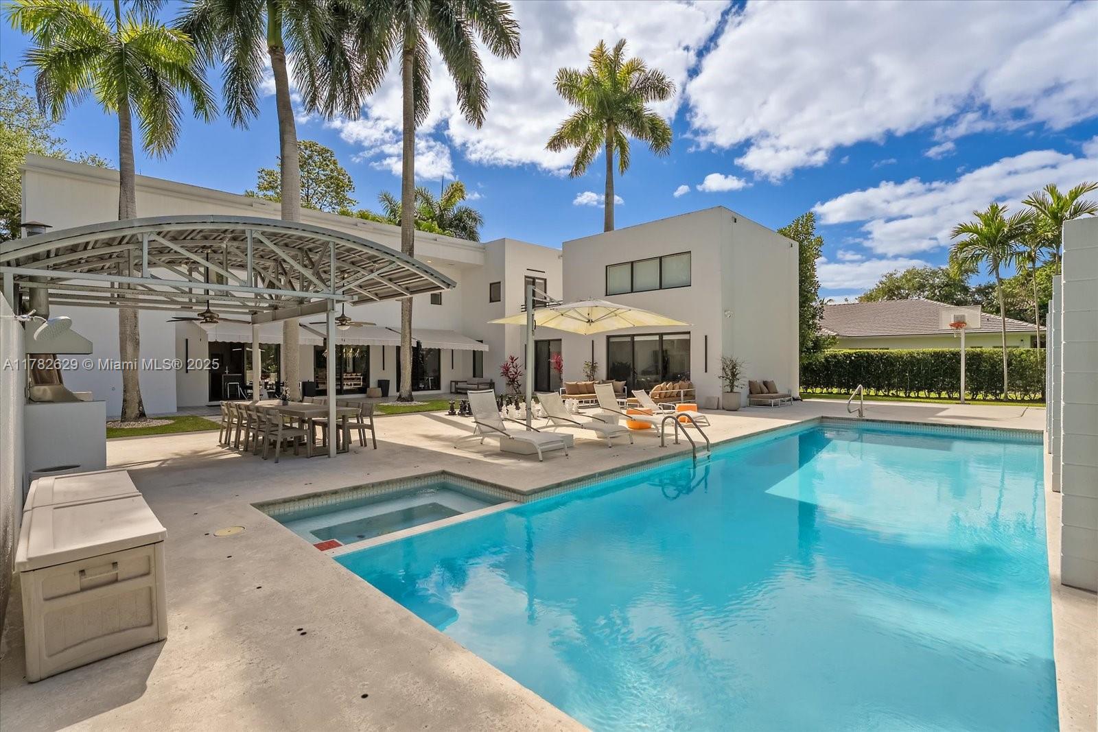 Discover this modern masterpiece in Pinecrest! Designed by renowned architect Roney J. Mateu, this exquisite home features 5 spacious bedrooms and 4 baths, plus living areas designed with an open floor plan that enhances social gatherings. The brand-new kitchen boasts top-of-the-line appliances, flowing into a huge dining room perfect for entertaining. On the opposite end of the home, a cozy family room provides a welcoming retreat. Step outside to your private oasis, complete with a heated pool, barbecue area, a basketball half court and fire pit - ideal for memorable gatherings. The property also includes a 3-car garage and a generator for added convenience. Located in a top-rated school zone, this home is a perfect blend of modern luxury and functionality!