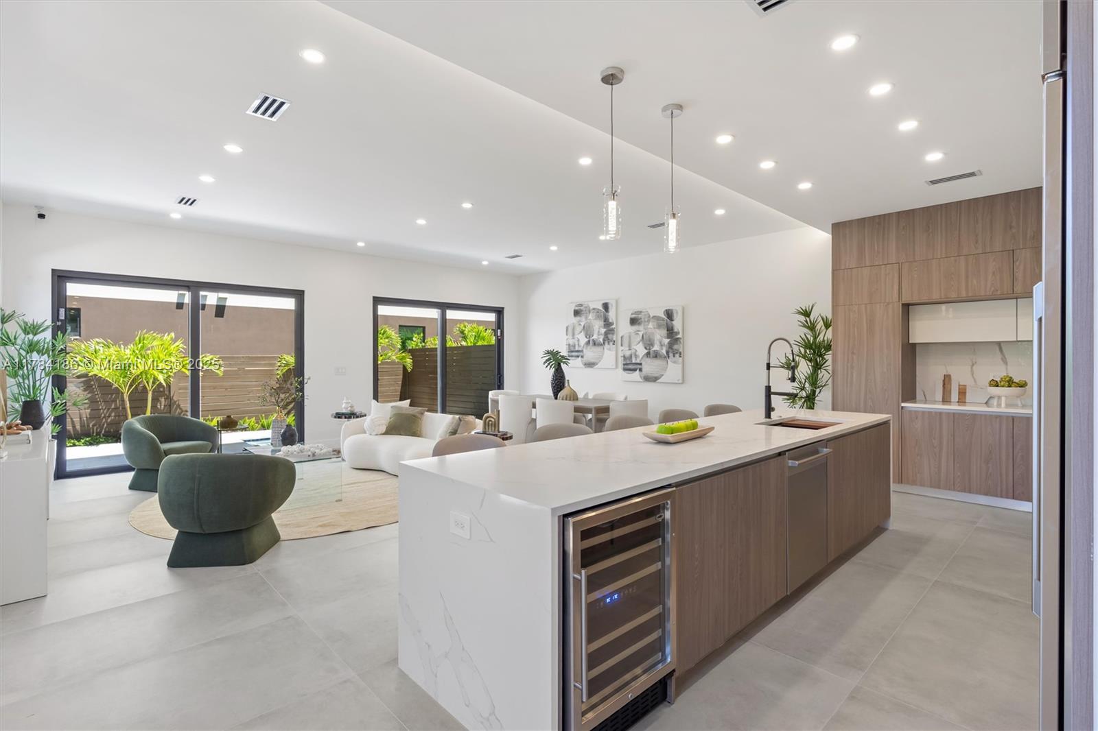 Discover modern elegance in Coral Ridge. This home features 4 bedrooms, 4 bathrooms, high ceilings, and an open concept living area that flows seamlessly into the terrace, thanks to multitrack sliding doors that create an extended indoor-outdoor space. Enjoy porcelain flooring, quartz countertops, custom solid wood doors, and a kitchen with state-of-the-art appliances. Designed with entertaining in mind, the home has an oversized rooftop terrace equipped with a summer kitchen and provisions for a jacuzzi installation. Additional amenities include a private pool, a security system, and ample parking with a double garage and four-car driveway. Panoramic views, along with relaxing balcony and deck areas for unwinding and enjoying the serene surroundings.