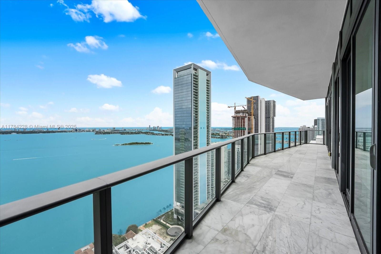 Soar above Biscayne Bay in this breathtaking south east corner penthouse at Icon Bay. Private elevator opens to open floor plan with 12-ft ceilings, sleek snow-white porcelain floors, and panoramic water and city skyline views. Stunning European kitchen with Wolf/Sub-Zero appliances and marble countertops. Expansive primary suite offers spa-style bath with soaking tub. Master bedroom and living room have east facing morning sunrise views, and sunset views from living and second bedroom. Bedrooms have ensuite bathrooms and built-out closets. Two parking spaces included. Icon Bay delivers resort-style amenities: bayfront pool, state-of-the-art gym, spa, tennis courts, theater, and a waterfront sculpture park. Luxury living meets artistic elegance in Edgewater’s most iconic address.