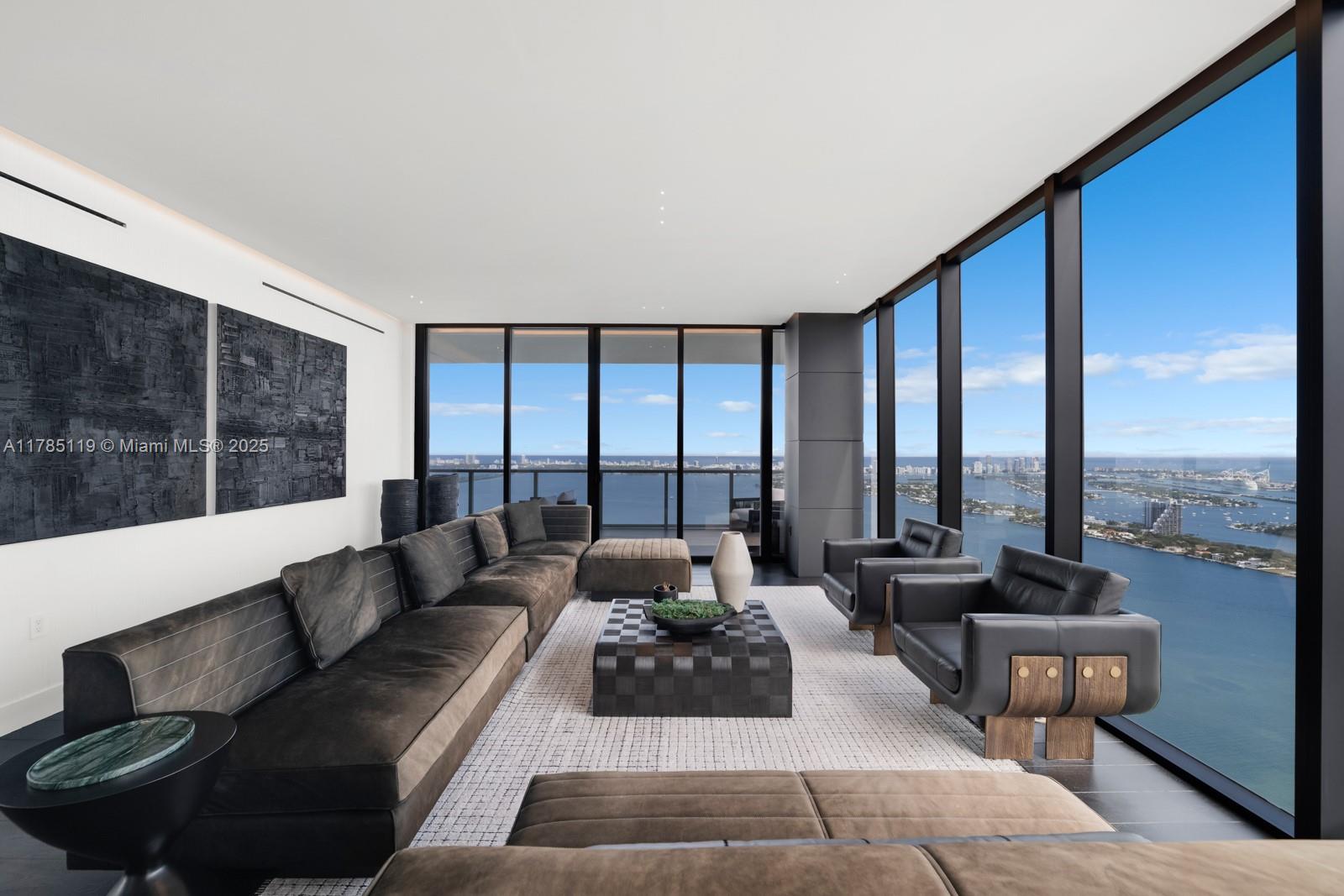 Unparalleled elegance meets sophistication in this one-of-a-kind residence. Customized & reconfigured into a 2BD layout featuring a theater w/ Mirro ceiling lighting system & custom blue velvet sofa that converts into a bed; expansive executive suite w/ a bespoke desk & ample seating by Monologue & StudioTwentySeven; a sophisticated library w/ custom shelving. Open living space is wrapped in floor-to-ceiling glass, revealing panoramic bay & city views. Custom-stained, burned, & wire-brushed oak floors by Urbanik Surfaces run throughout. The kitchen is a showpiece w/ Nuvolato Apuano marble countertops, Italian marble flooring, GAM Woodwork cabinetry & chef-grade appliances. The grand primary suite, accented w/ walnut paneling, features a waterfront terrace, spa-like bath, & custom wardrobe.