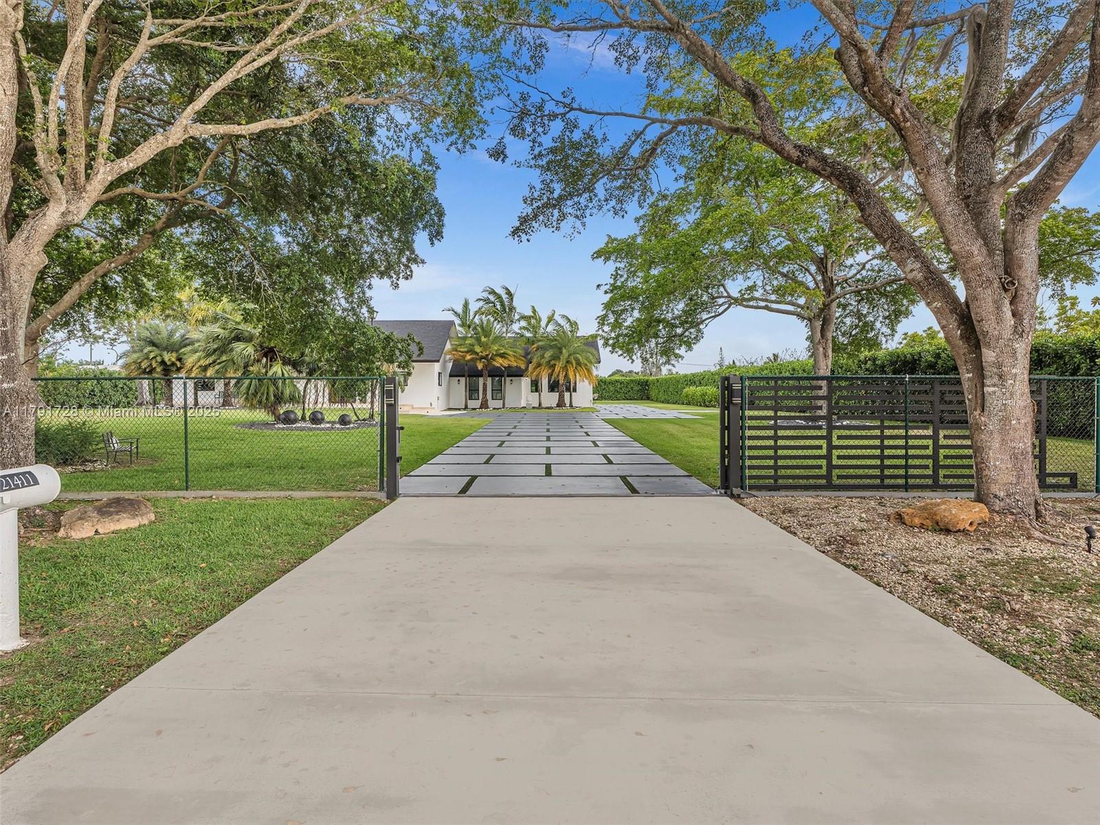 Stunning Redlands estate on 1.29 acres! This 5 bed, 4 bath home offers beautifully upgraded living space and is designed for unforgettable entertaining. Enjoy a resort-style outdoor pavilion, charming courtyard, covered terrace with summer kitchen, and a large 20x40 pool with custom lighting. Host with ease thanks to a massive driveway for 20+vehicles, 3 motorized gates, and a full outdoor projection and surround sound system. Features include a new roof, 26KW whole-house generator (powers home up to 2 weeks), impact windows/doors, updated electrical & plumbing. Inside: indoor jacuzzi, glass wine cellars, loft, and built-in TVs. Lush 12-ft privacy hedges and custom landscape lighting showcase the tropical grounds, including rare rainbow eucalyptus trees. A true private oasis—move-in ready!