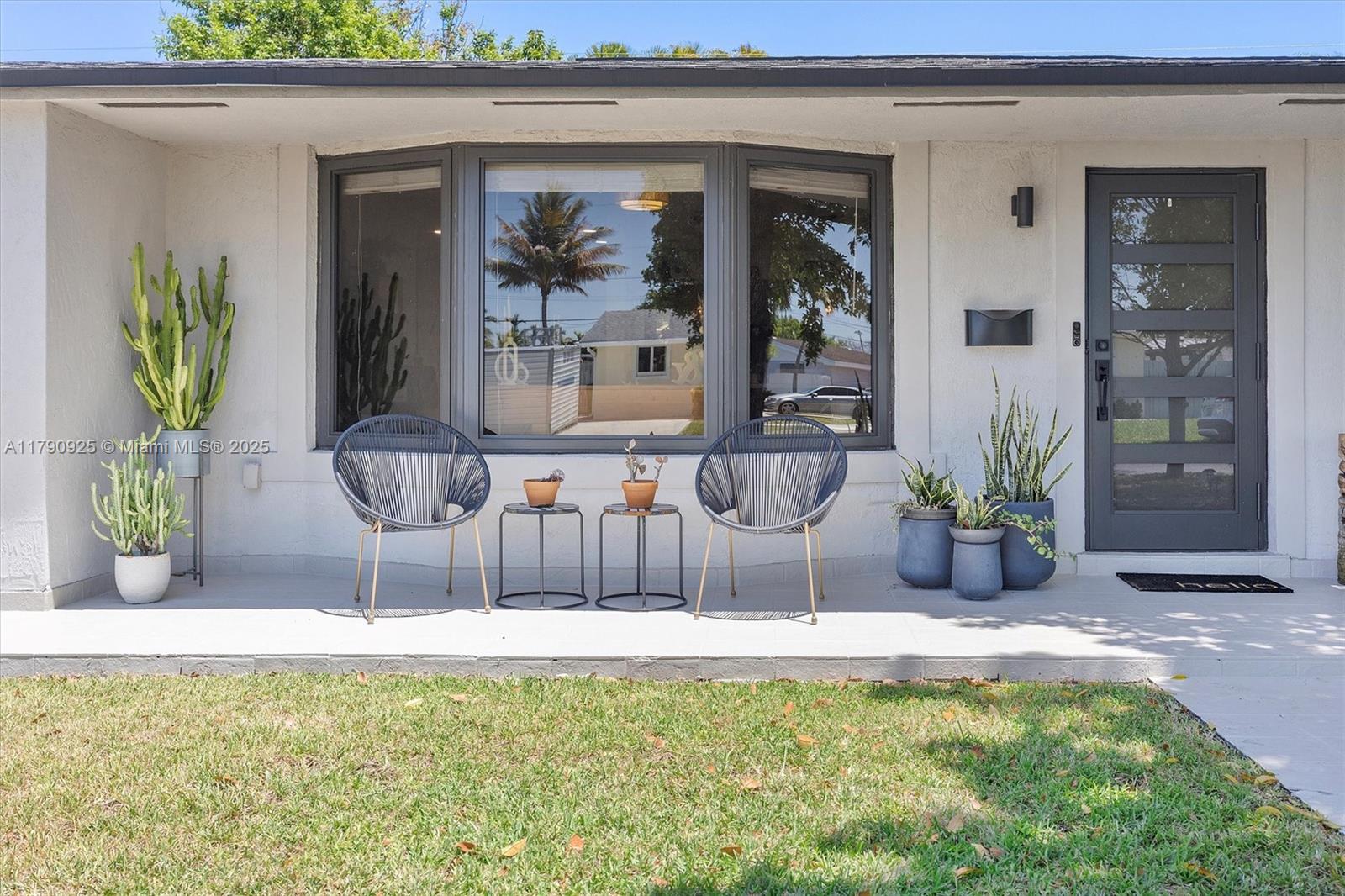 Bright and updated 3 bedroom, 2 bathroom home with a welcoming mid-century modern aesthetic. Restored terrazzo floors flow through the open living spaces and bedrooms. The open kitchen is a standout with walnut cabinets, Quartz countertops and newer Stainless Steel KitchenAid appliances. Bathrooms feature matching walnut vanities and elegant brass fixtures for a cohesive flow. You'll enjoy the screened Florida room—perfect for relaxing or entertaining—overlooking an above-ground pool with room to add an in-ground option. Hurricane impact windows and doors, new A/C, 2018 roof, one-car garage, and a double-wide side gate with space for RV or boat. Stylish and move-in ready!
