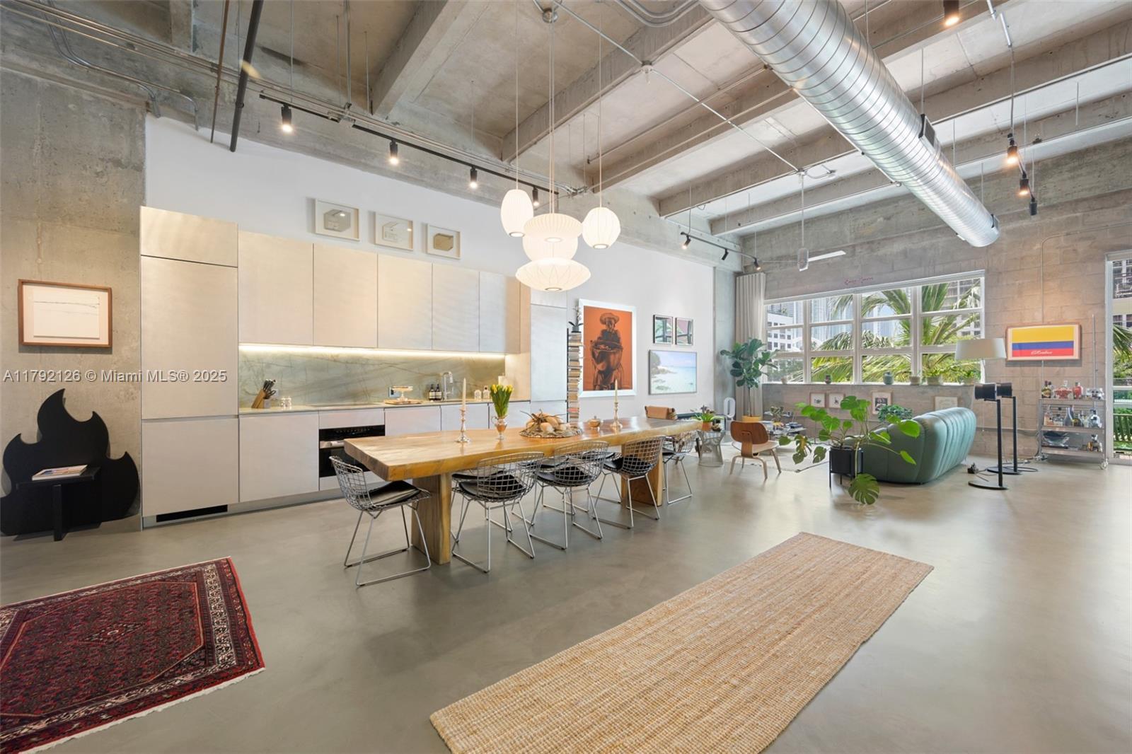 Stunning corner loft with soaring 15-ft ceilings and over $100K in high-end upgrades. This 1203 SF residence at Parc Lofts showcases a fully redesigned kitchen with quartzite countertops, Miele appliances, a wine fridge, and sleek stainless finishes. All fixtures have been upgraded to Buster + Punch, while a smart Caseta by Lutron lighting system—compatible with Alexa, Google Home, and more—offers seamless control. Custom closets, a built-in office, premium flooring, and a spa-quality bathroom elevate the space. Oversized windows fill the loft with natural light and offer beautiful southeast views. Boutique building amenities include a 24-hour doorman, gym, pool, and spa. Walk to Miami Slice, Vice City Bean, and Canvas rooftop. Minutes to Wynwood, Brickell, Edgewater, and Downtown