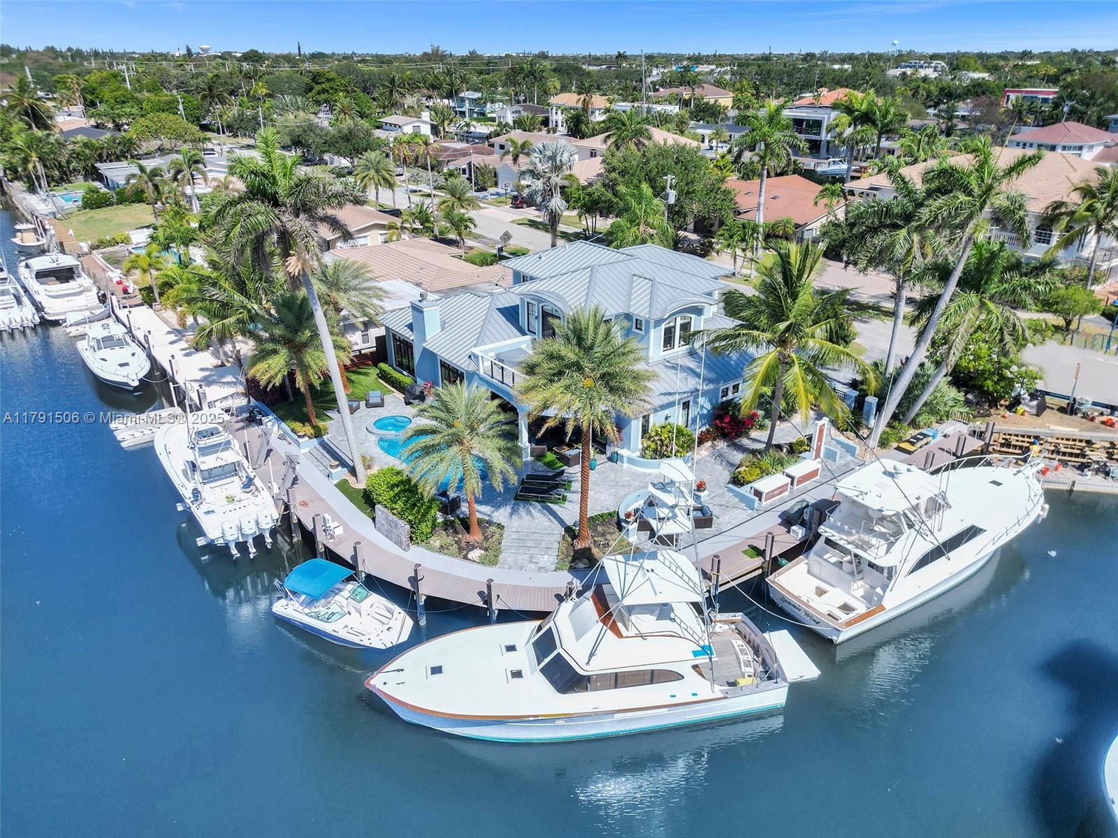 Custom-built West Indies-style masterpiece located on a prime point lot in beautiful Lighthouse Point! Boater’s paradise with just under 200 feet of deep water frontage and no fixed bridges to the ocean. 24,000 LBS Boat Lift. This elegant home features Miele appliances, a stunning quartzite island, white oak hardwood floors, 12-foot ceilings, and exquisite coffered ceilings in the living room and master suite. Enjoy luxurious outdoor living with a heated saltwater pool, jacuzzi, and marble driveway and back patio. An extraordinary waterfront lifestyle awaits!