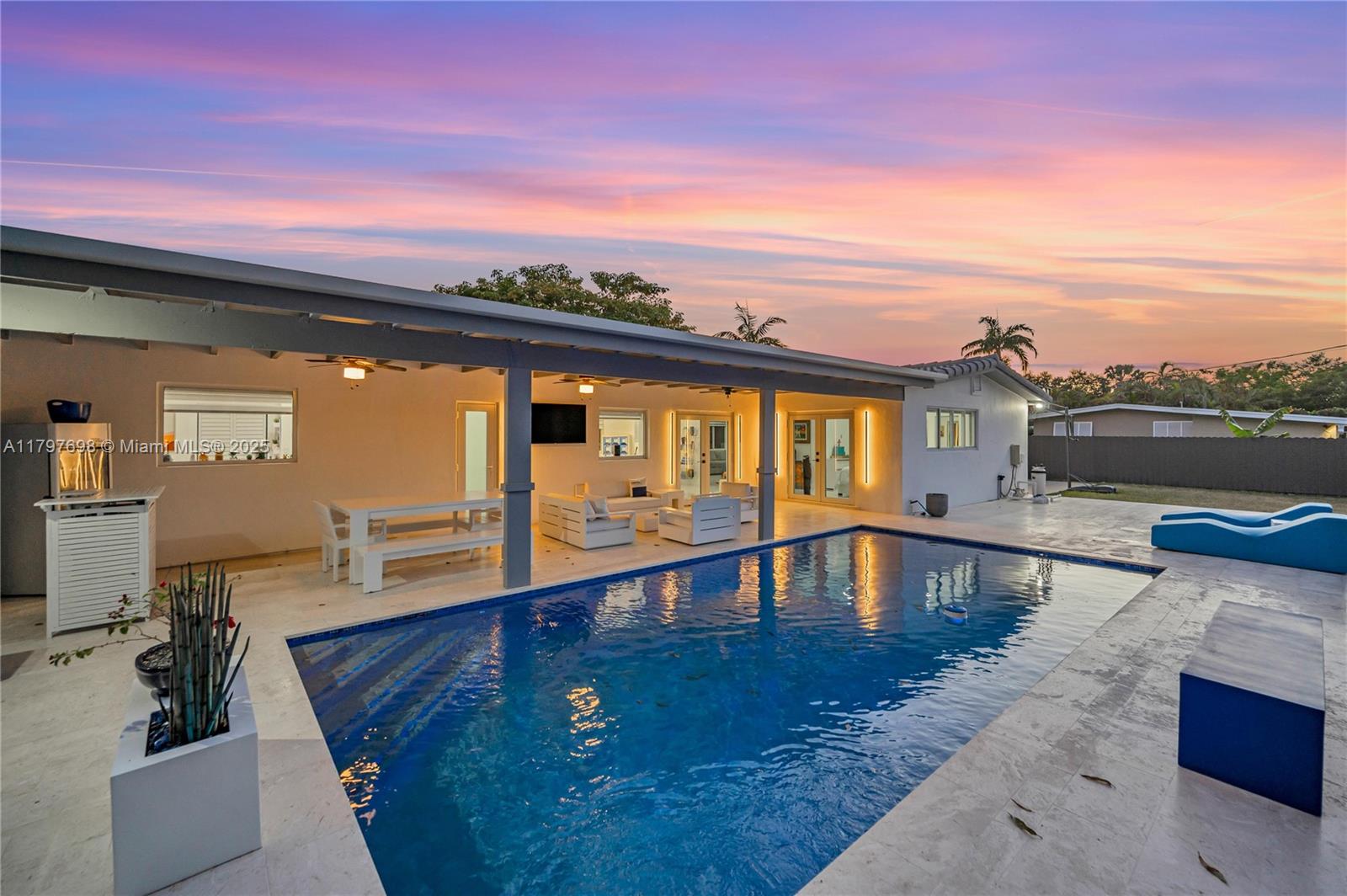 Stunning pool home on a huge corner lot! Beautifully remodeled with the perfect split floor plan, Italian porcelain floors, spacious living areas and tons of natural light. Bedrooms are all generously sized with the primary room offering French doors with access to the pool area. Modern open concept kitchen, ideal for the entertainer & complete with new cabinetry & top-of-the-line appliances, making it truly the heart of the home. Let the party spill out onto the gorgeous covered resort style patio transporting you to Santorini! Expansive lot with plenty of room for your boat, R/V or play area. Updates: impact windows, Roof from 2022, AC 2023 & updated electrical and plumbing. Located just minutes from Coral Reef Park this neighborhood provides access to excellent public / private schools.