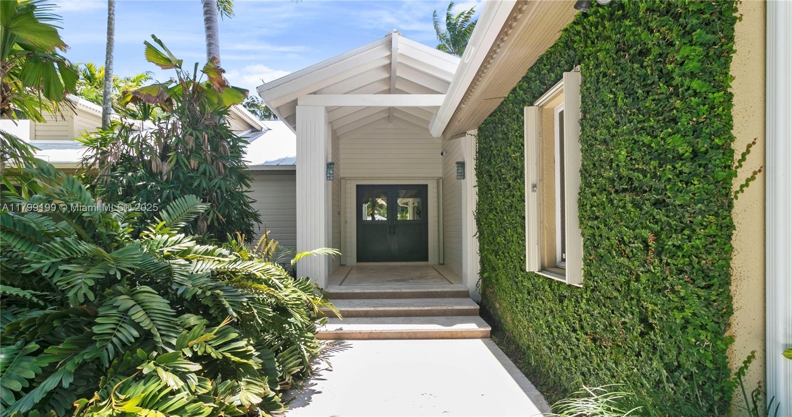 There might be others, but nothing quite like this. Hidden behind a throughtfully designed landscape lies an exceptional Key West-style home created with entertaining in mind. A picturesque foyer opens to a stunning great room that seamlessly combines living, dining, and a chef's kitchen with Wolf/Sub-Zero appliances and quartzite countertops. The expansive primary suite offers a spa-like retreat, while the secondary bedrooms are throughfully set apart to maximize privacy. Outside, enjoy a sun-drenched patio, sparkling pool, full house generator and a freshly resurfaced tennis court. A rare blend of comfort, style, and indoor-outdoor living.