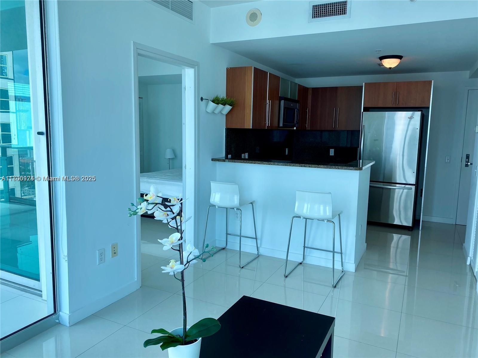 Experience stunning city and partial water views from this highly sought-after corner unit in the "11" line. Featuring a spacious large balcony with NW exposure and elegant tile flooring throughout, this home boasts Italian cabinetry, granite countertops and stainless steel appliances. Cable and internet are included, 1 assigned parking space. convenience of walking to Whole Foods Market, Bayfront Park, metro mover and popular dining options like Novikov Restaurant, Hell's Kitchen, and Joe & the Juice.Silverspot Cinema nearby and a vibrant mix of sports, arts, restaurants and shops. The building provides a luxurious living experience, complete with a 24-hour front desk attended for your convenience. Note that the pool is currently closed for repairs.