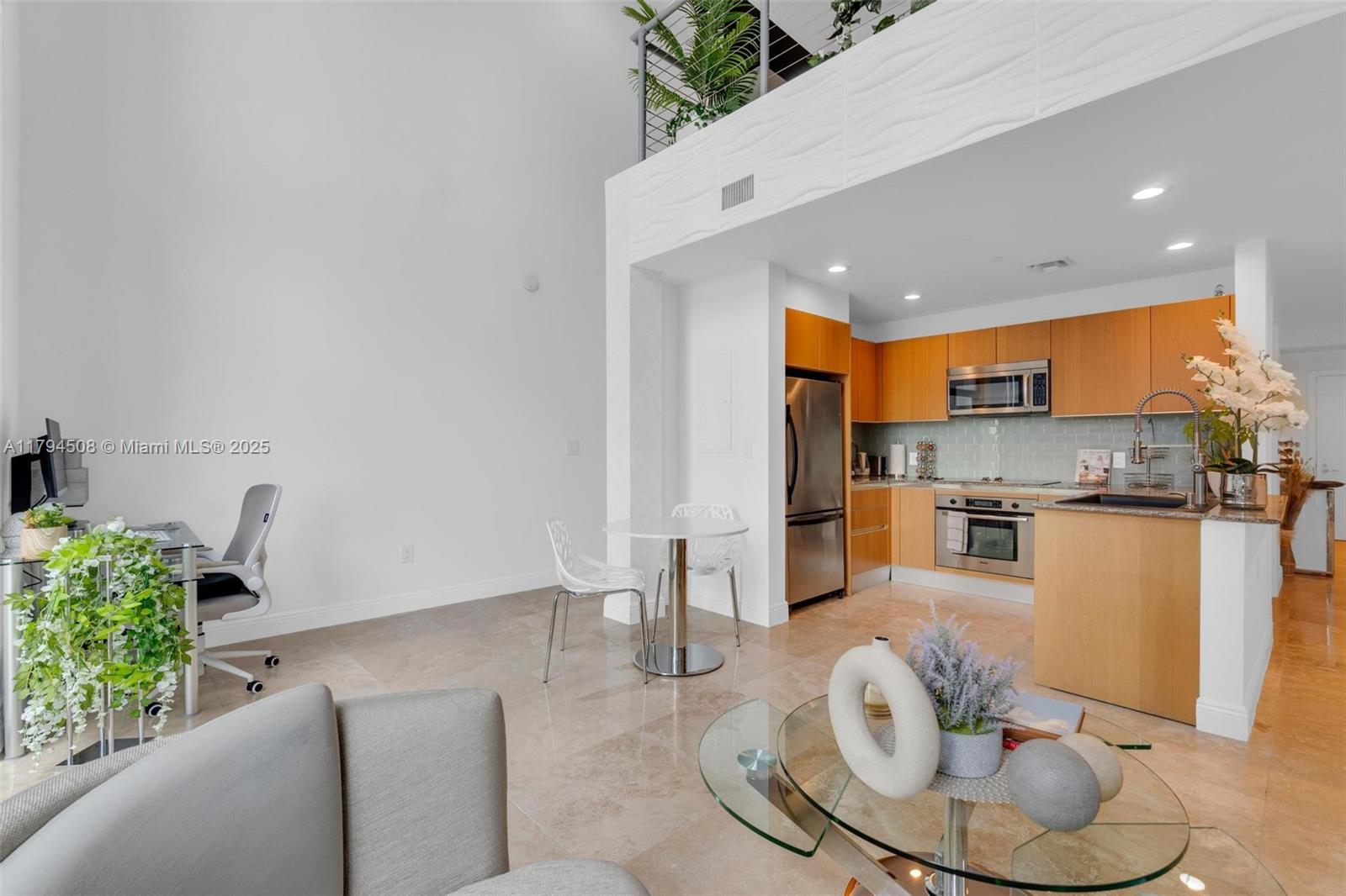 Live in style in this beautiful 1-bedroom, 1.5-bath loft in the heart of Brickell! Located on the 24th floor, this modern condo has tall 20-foot ceilings, large windows, and amazing city views. You’ll love watching the sunset from your spacious living room.
The kitchen is modern with Italian cabinets and granite countertops. The bedroom is upstairs and private, with its own bathroom. The condo has new floors, remodeled bathrooms, and electric shades for the windows. Everything is upgraded and ready for you to move in! Comes with assigned parking and is close to Key Biscayne, Coconut Grove, and Coral Gables. This is the perfect place to enjoy city living in Miami!